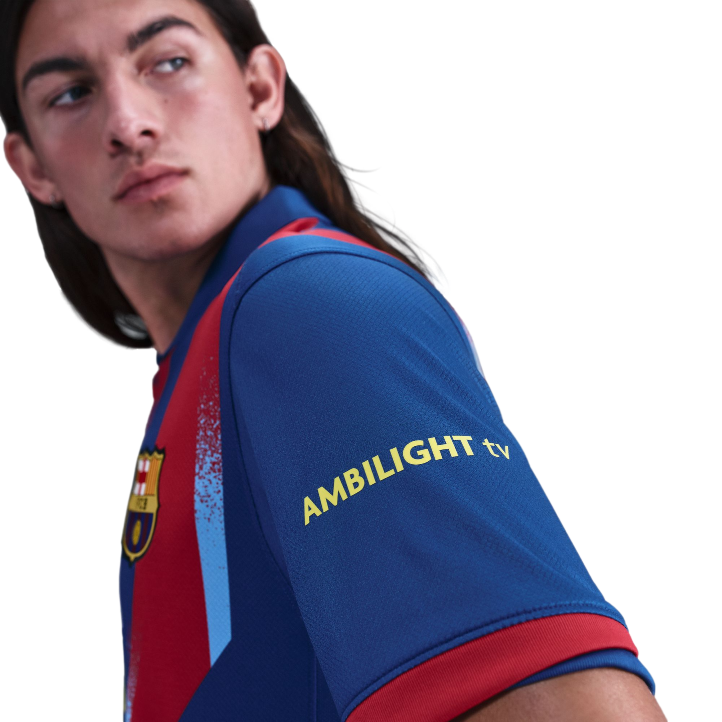 A person with long hair wearing an FC Barcelona soccer jersey with "AMBILIGHT tv" on the sleeve, looking back over their shoulder against a black background.