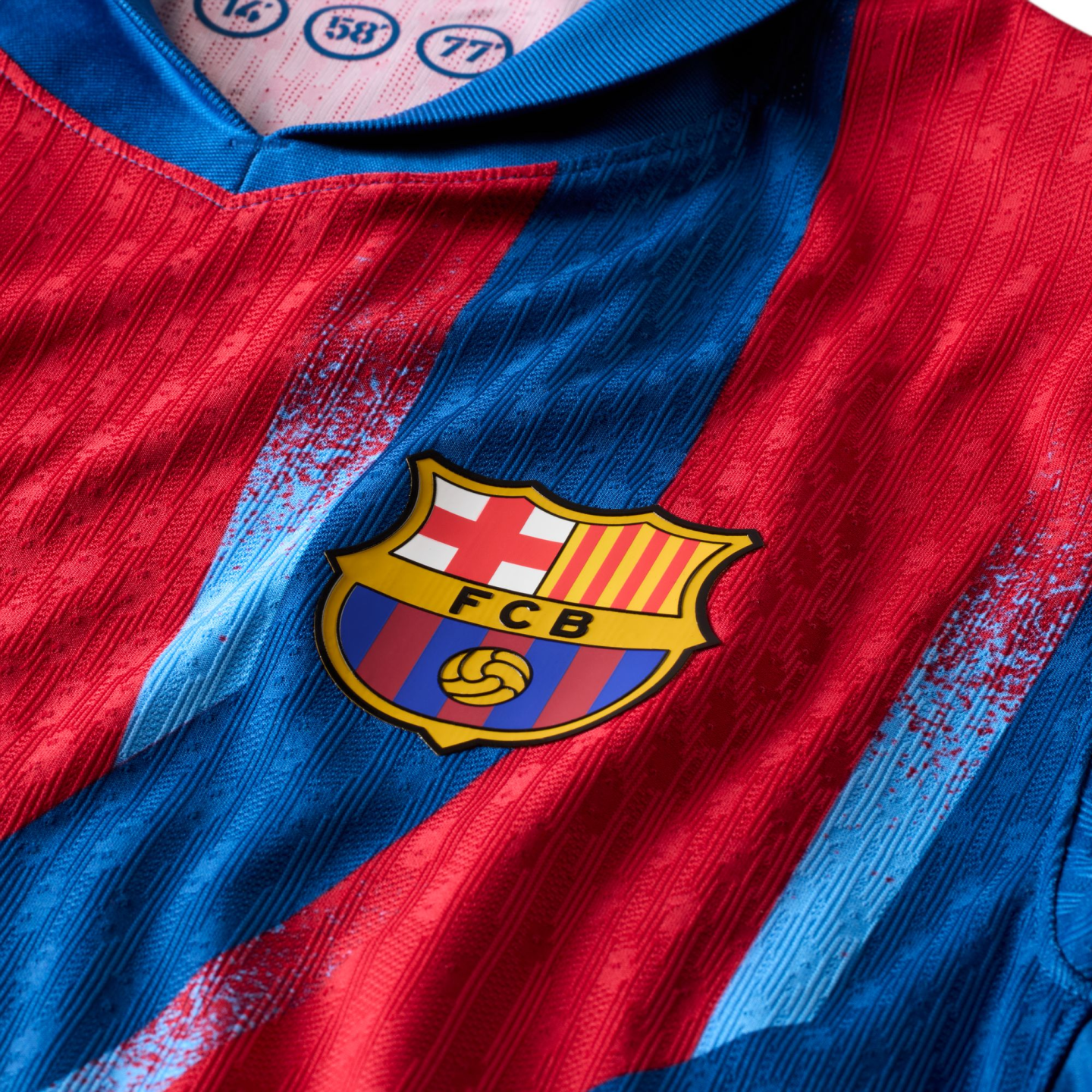 Close-up of an FC Barcelona home football jersey featuring red and blue vertical stripes and the club's iconic crest.