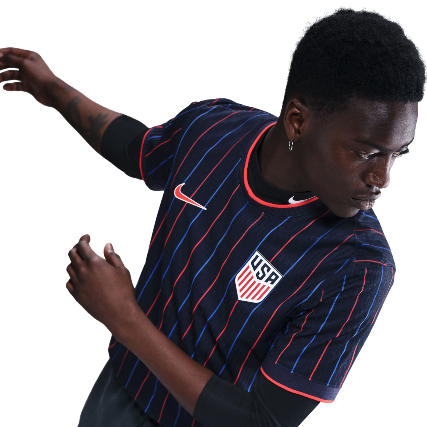 A Black man in a navy USA soccer jersey with red and blue pinstripes, featuring the Nike logo and team crest. He is in a dynamic pose against a white background.