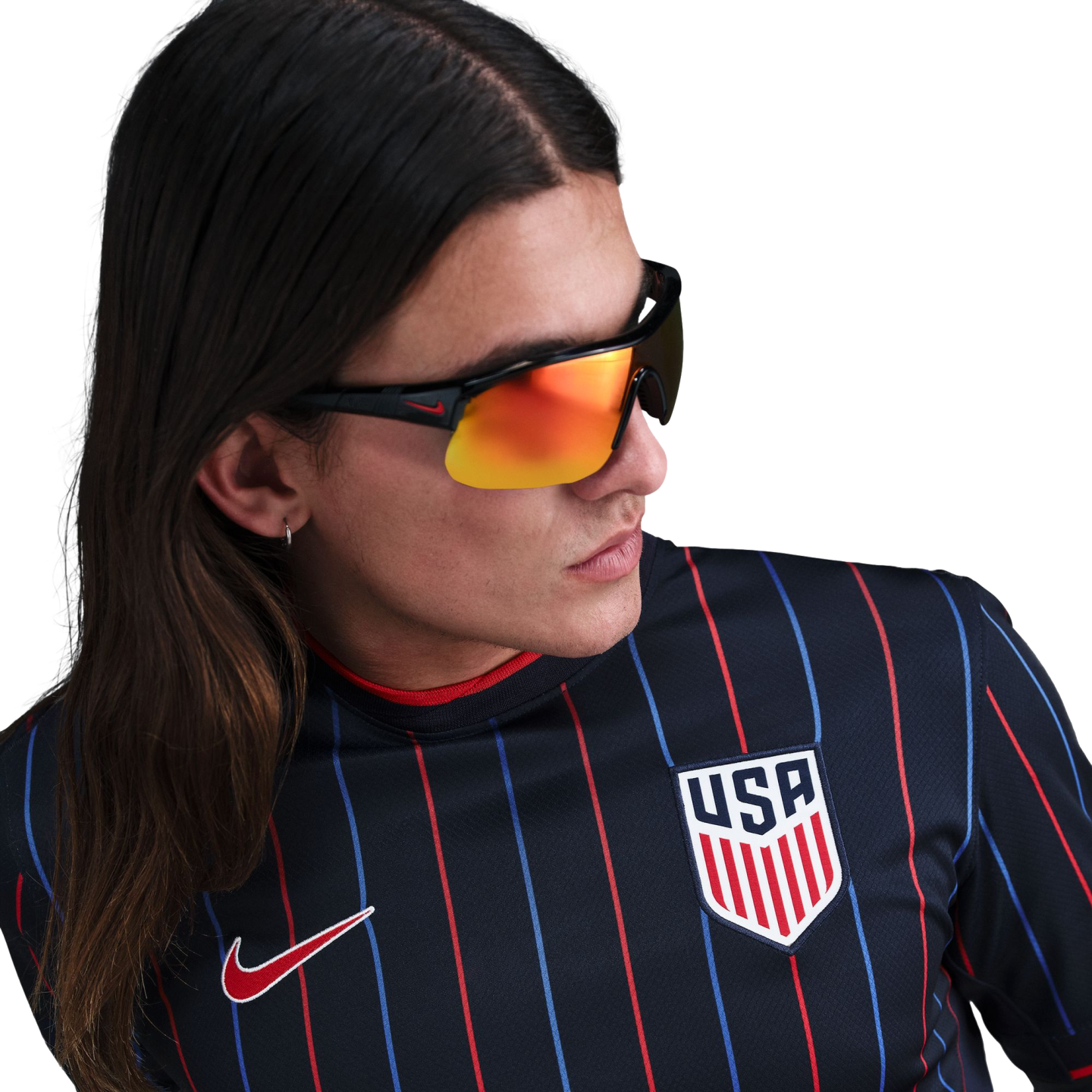A person with long hair wearing a navy blue USA soccer jersey with thin red and blue stripes and orange reflective sunglasses.