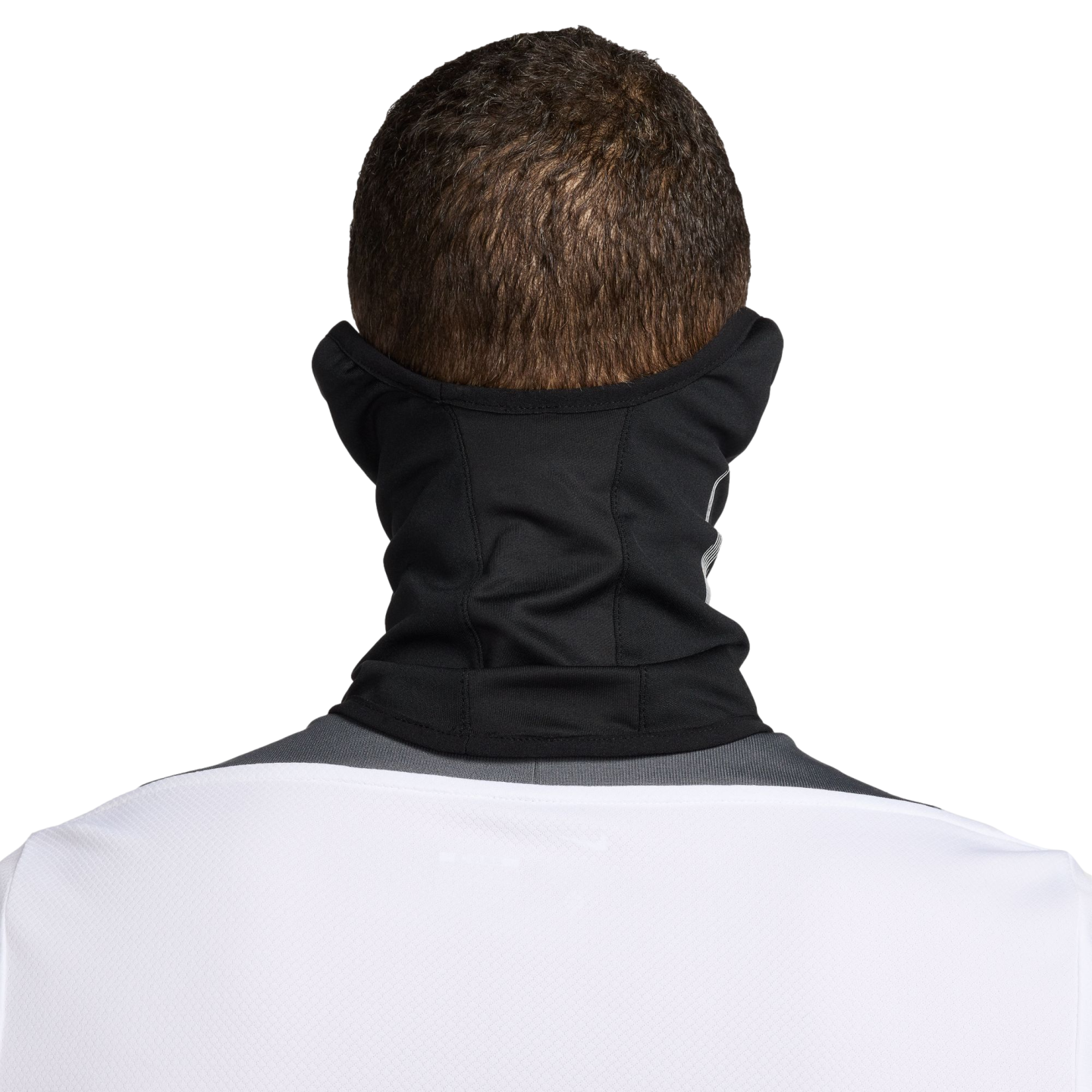 Back view of a person with short brown hair wearing a black neck gaiter and a white jersey against a black background.