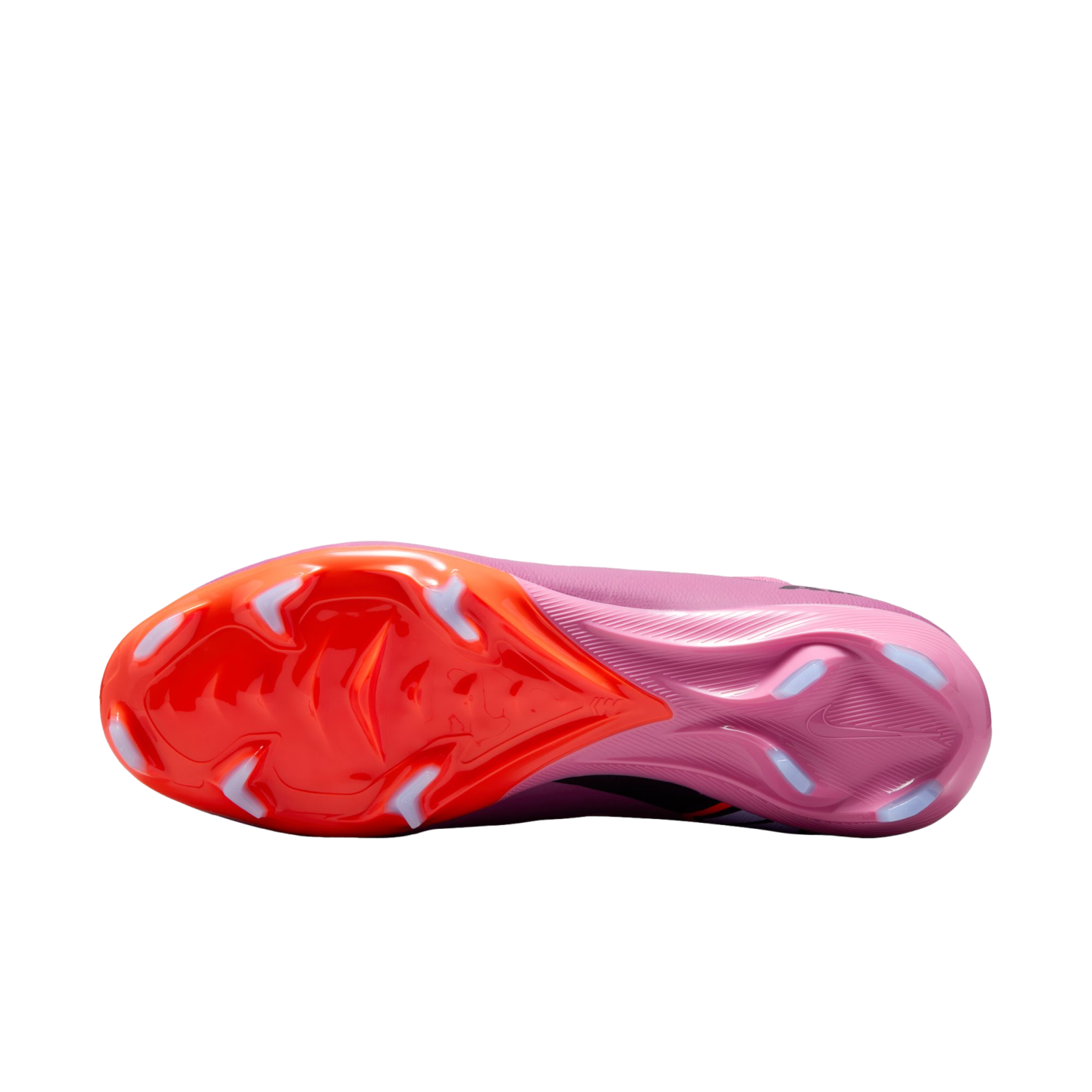 Bottom view of a Nike soccer cleat with an orange-to-pink gradient sole and white chevron-shaped studs, isolated against a black background.