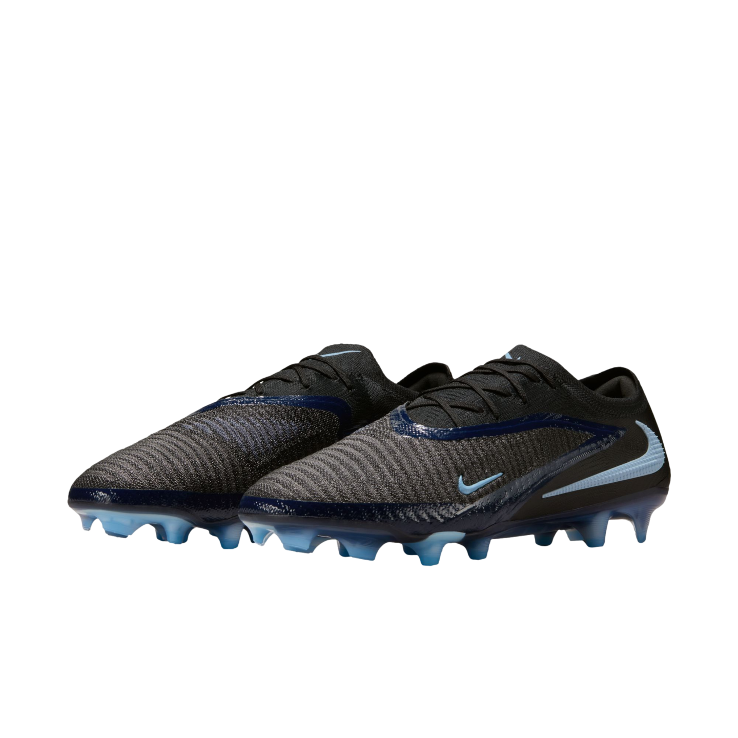 A pair of black and dark grey Nike soccer cleats with light blue accents and studs, set against a solid black background.