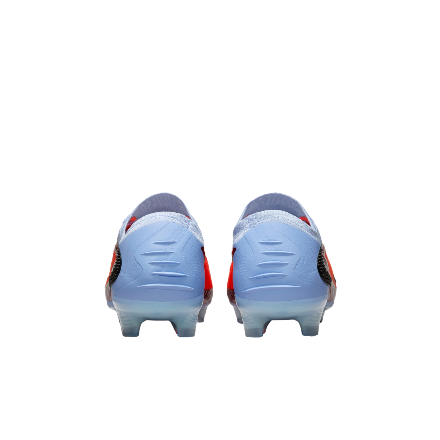 Rear view of a pair of light blue Nike soccer cleats with red and black accents against a black background.