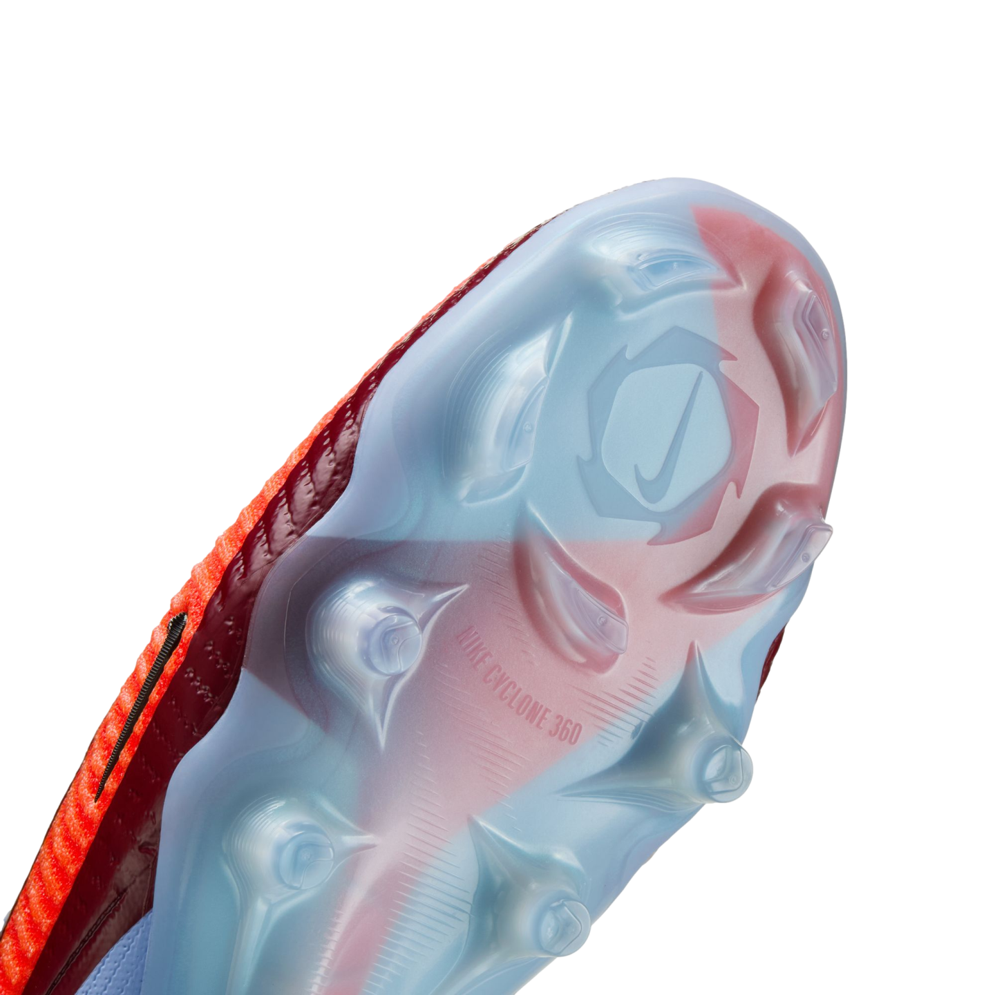Close-up of a translucent blue and red Nike soccer cleat sole plate showing various studs and the "NIKE CYCLONE 360" branding.