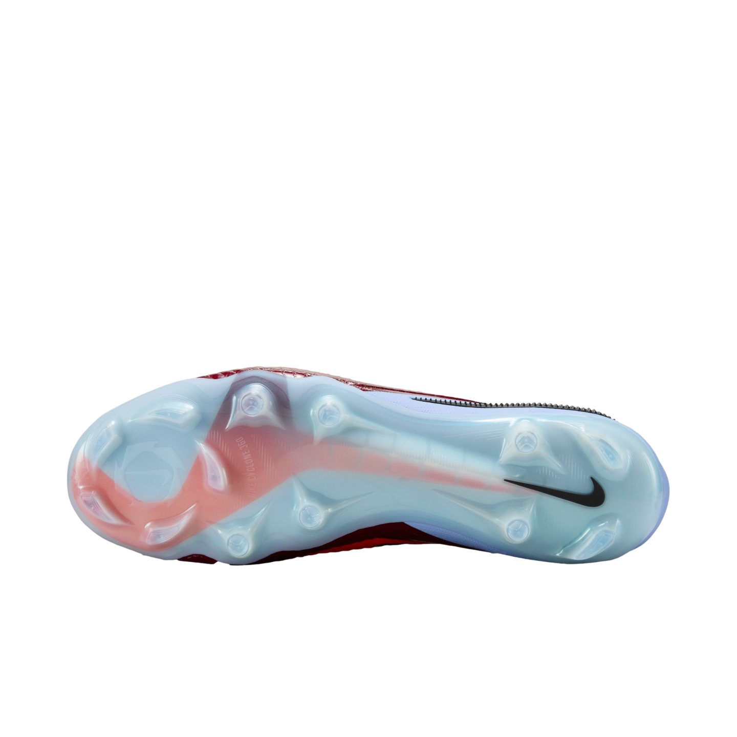 Bottom view of a Nike soccer cleat's light blue and red soleplate featuring various studs and a black swoosh, centered on a black background.