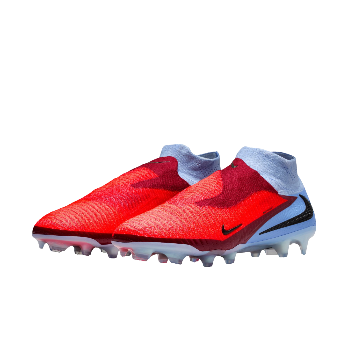 A pair of red and light blue Nike laceless soccer cleats with high-top ankle collars, set against a black background.