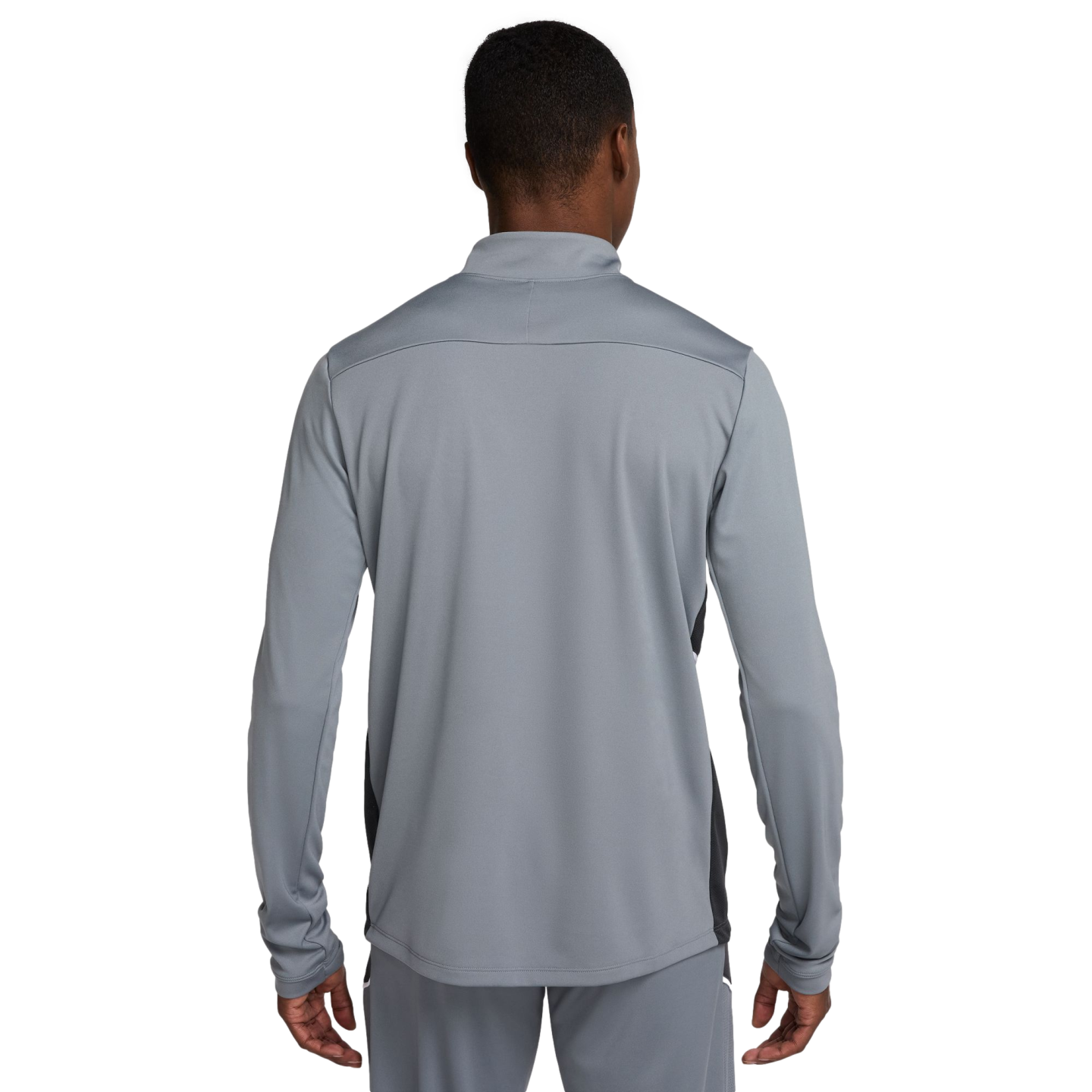 A man seen from behind wearing a grey athletic tracksuit set. The long-sleeved top features black side panels and a high collar.