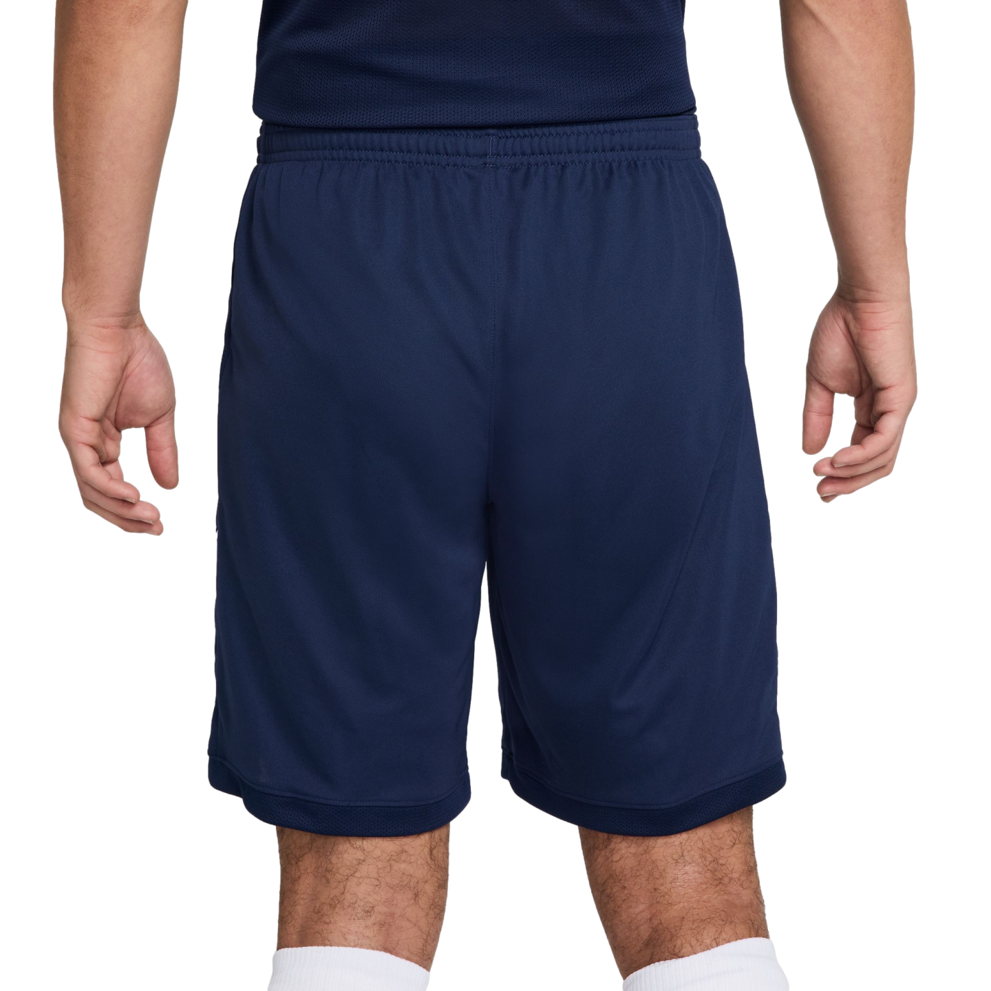 Rear view of a person wearing navy blue athletic shorts and a matching top.