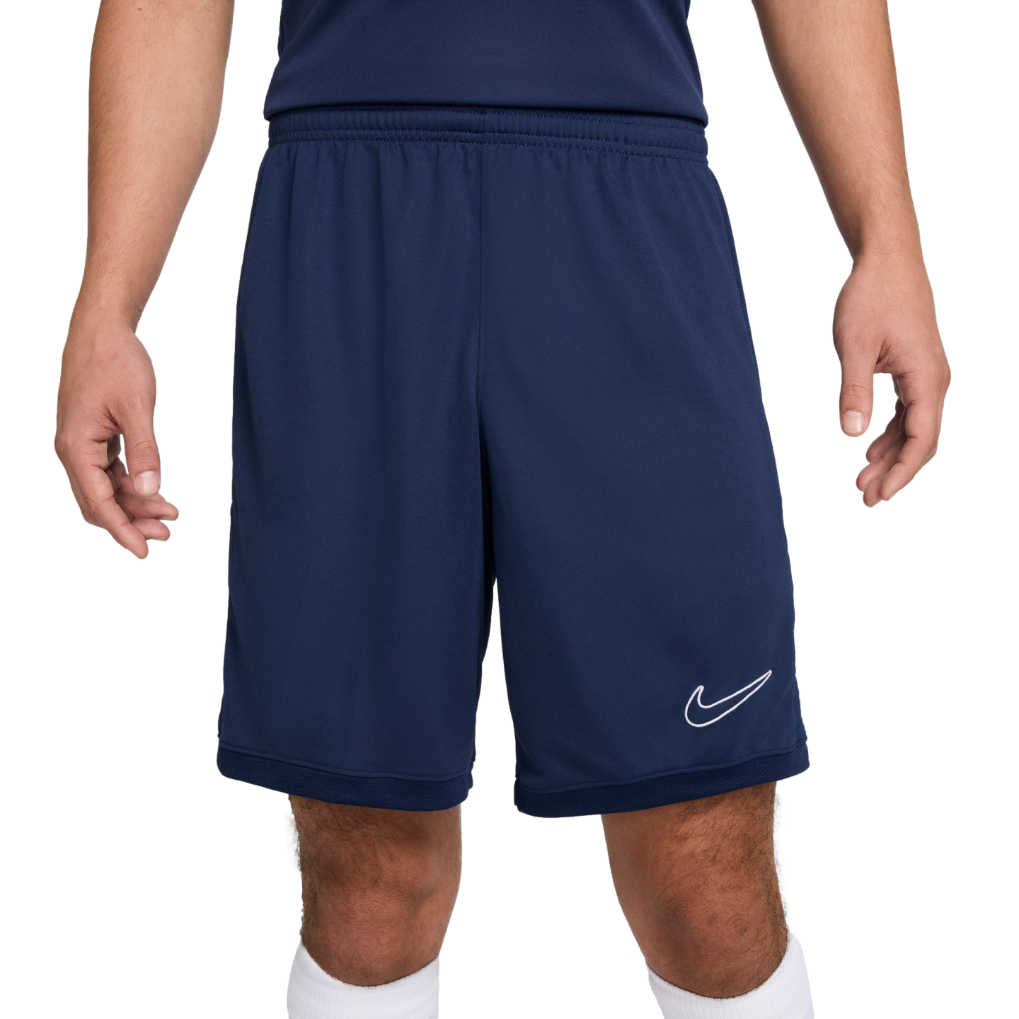 A person wearing navy blue Nike athletic shorts with a white swoosh logo on the bottom left leg.