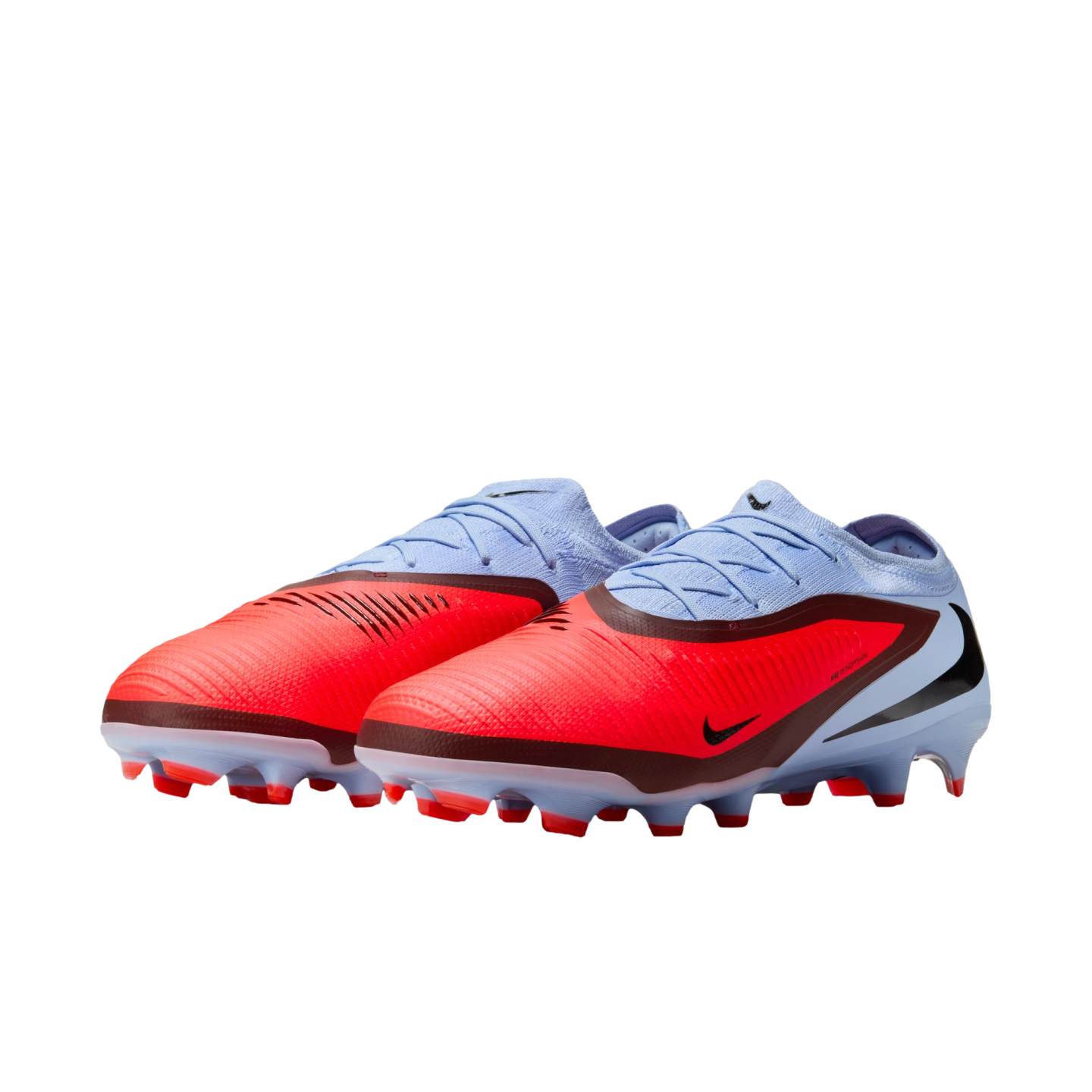 Vibrant red and light blue Nike soccer cleats with black accents, shown from a side-angle view against a solid black background.