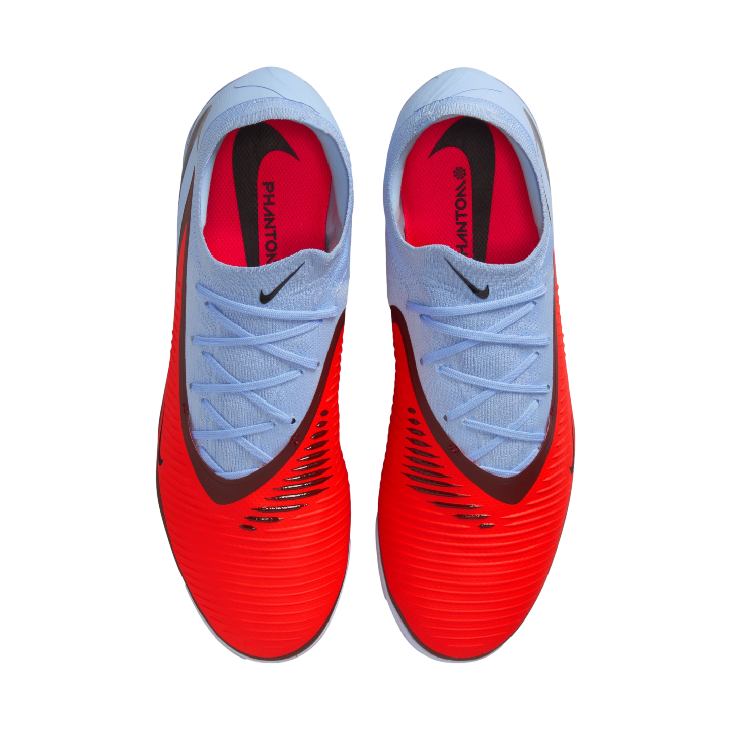 Top-down view of Nike Phantom soccer cleats with a bright red textured forefoot and light blue heel and laces against a black background.