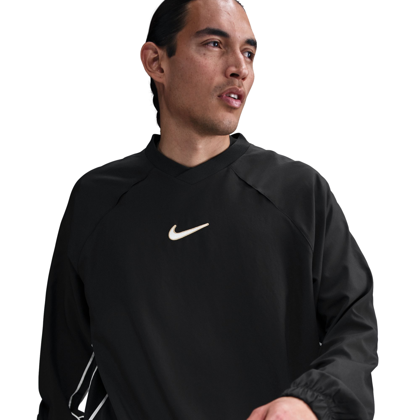 A man wearing a black long-sleeved Nike shirt with a white swoosh logo on the chest, looking to the side against a white background.