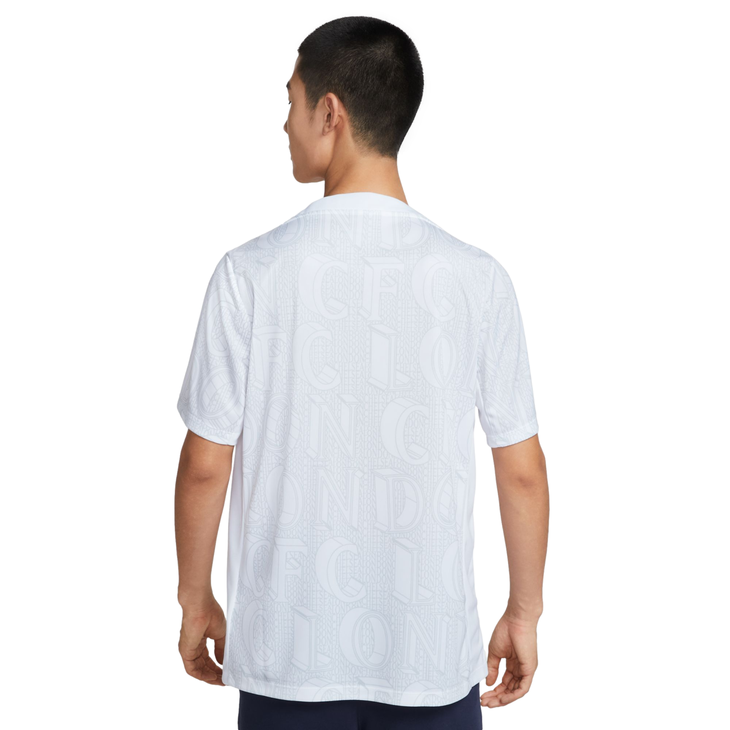 Rear view of a person wearing a white short-sleeved shirt with a subtle, all-over "CFC LONDON" typographic pattern.