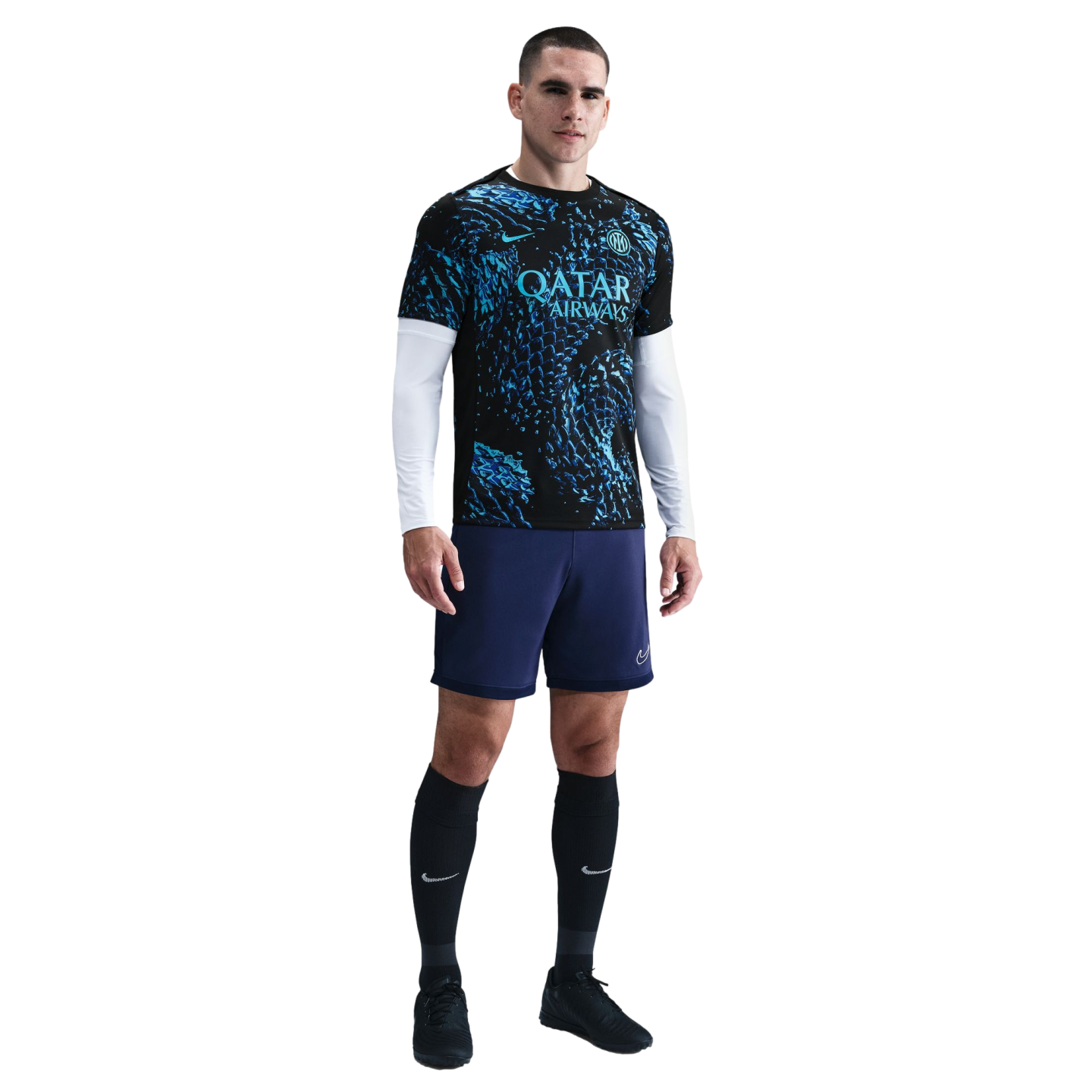 Male athlete standing in a black and blue Inter Milan kit, white compression sleeves, navy shorts, and black socks against a plain white background.