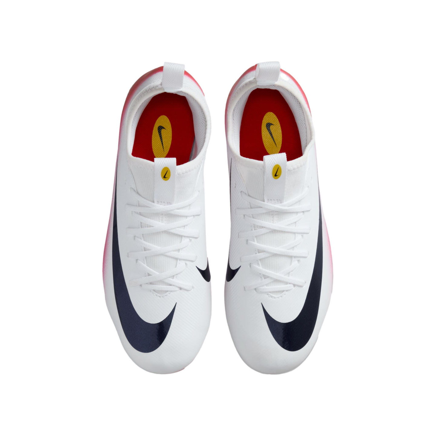 Top-down view of white Nike soccer cleats with large dark blue swooshes, white laces, and red interior, set against a solid black background.