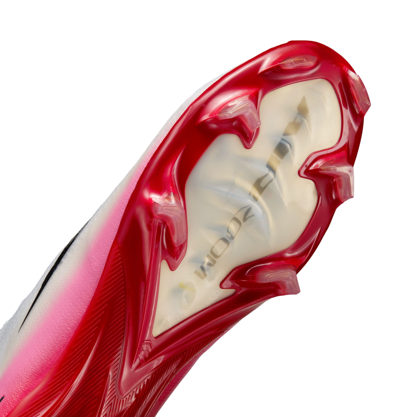 Close-up of the soleplate of a pink and red Nike Mercurial soccer cleat featuring translucent windows and bladed studs on a black background.