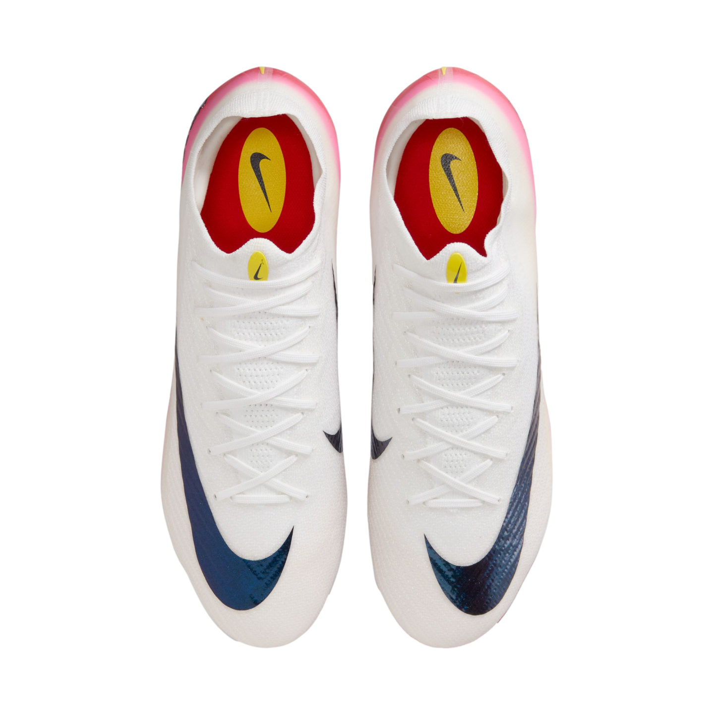 Top-down view of a pair of white Nike soccer cleats featuring iridescent blue swooshes, white laces, and pink heel accents on a plain white background.