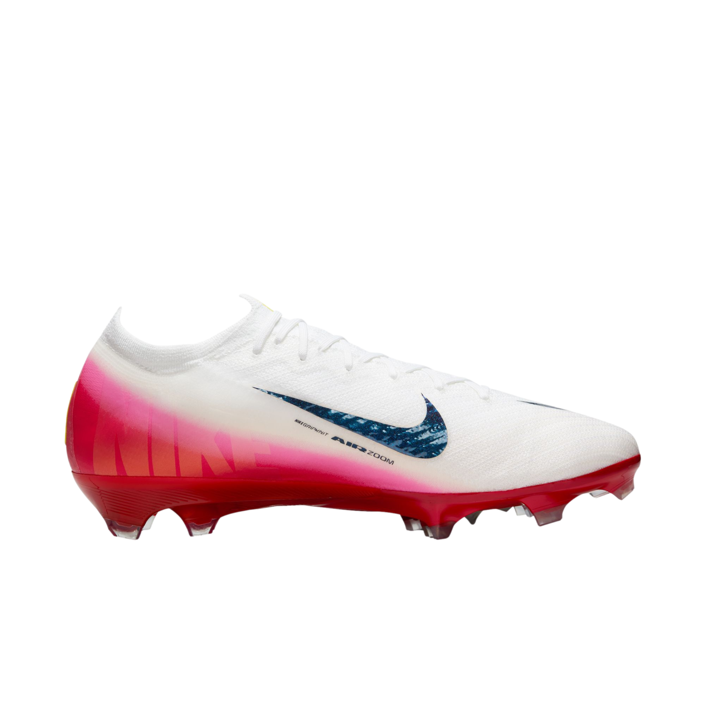 A white Nike soccer cleat with a pink and red gradient base, featuring a blue textured swoosh and "AIR ZOOM" text on the side.