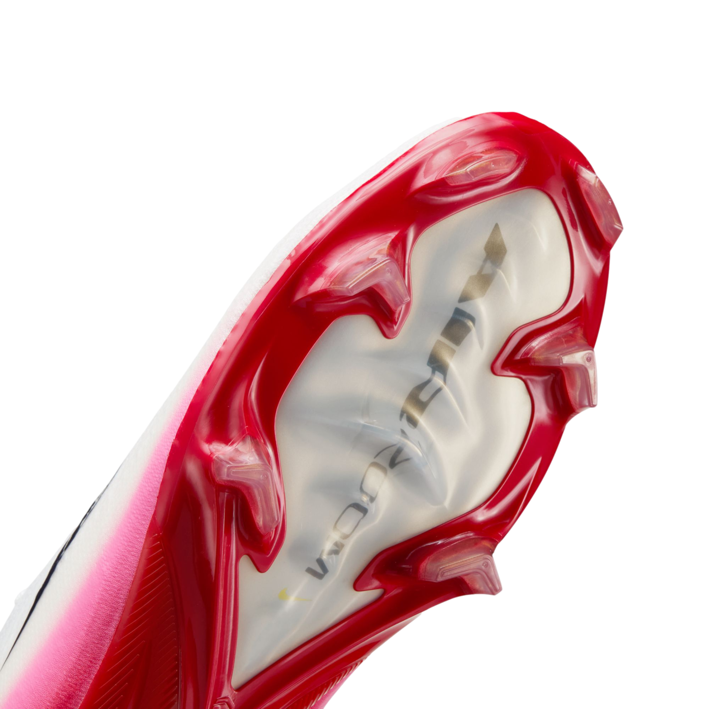 A close-up view of the soleplate of a red and pink Nike soccer cleat, showcasing its sharp red studs and a translucent center featuring 'AIR ZOOM' branding.
