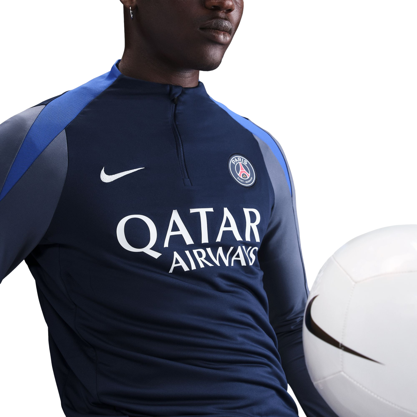 A person wearing a navy Nike PSG training top with "QATAR AIRWAYS" logo, posing with a white soccer ball.