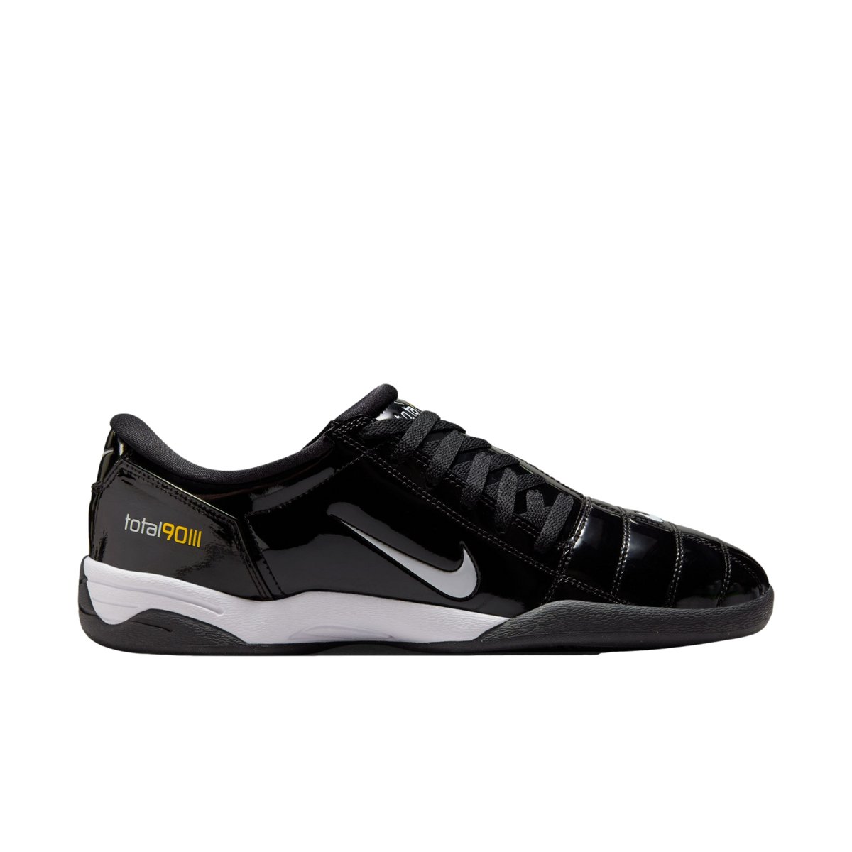 A side-profile view of a shiny black Nike Total 90 III indoor soccer shoe with a silver swoosh, white midsole, and black outsole.