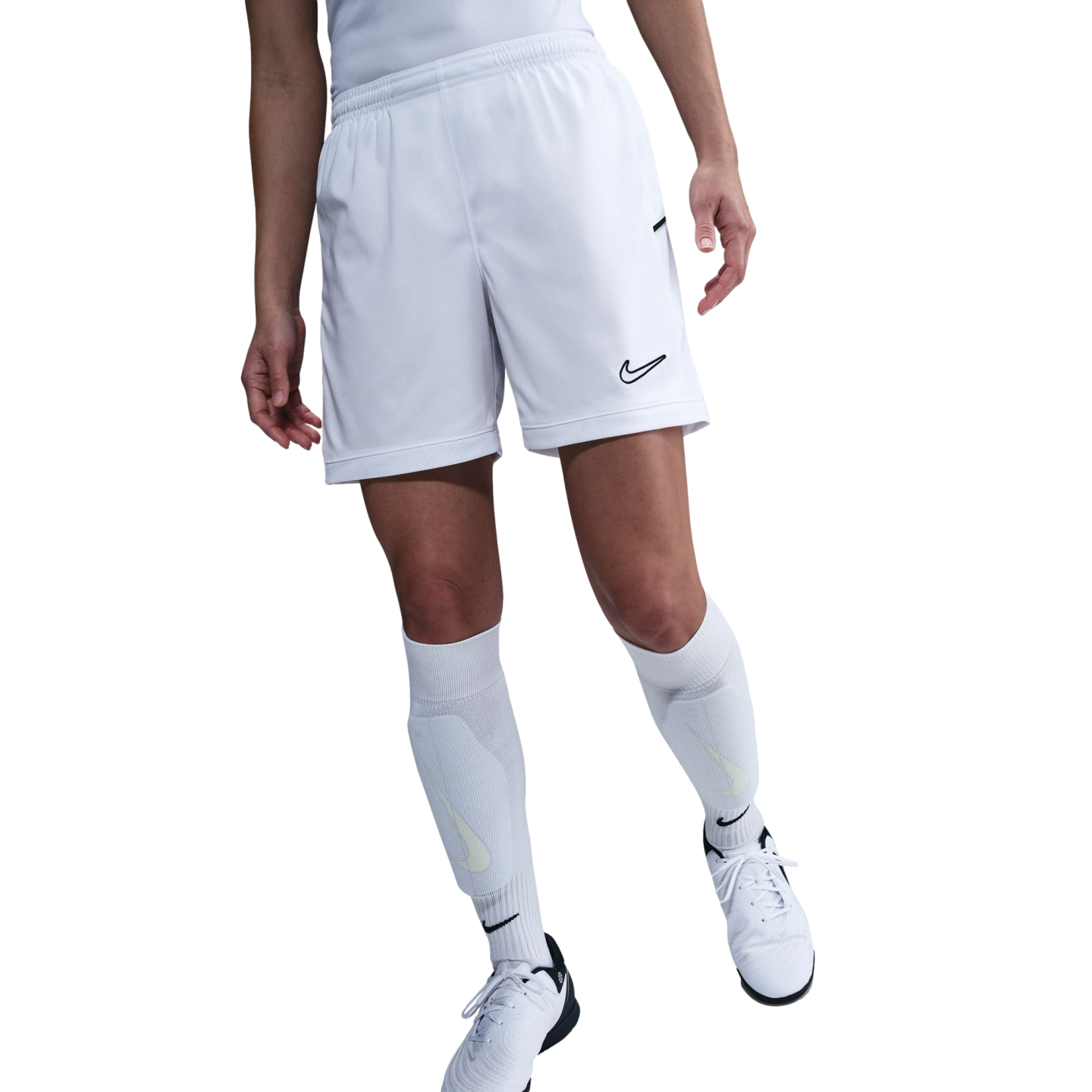 Lower half of a person wearing white Nike soccer shorts, knee-high socks, and cleats against a white background.