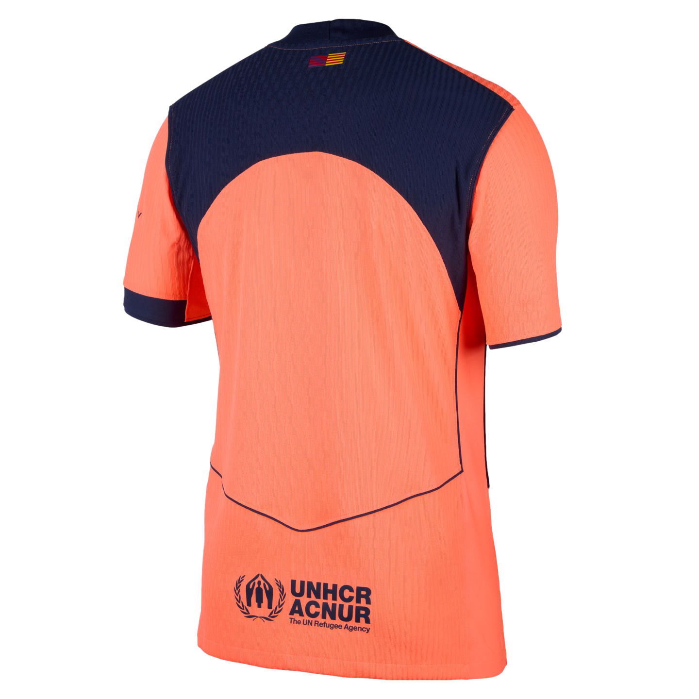 Back of an orange and navy blue soccer jersey featuring a small flag on the upper back and a UNHCR ACNUR logo at the bottom.