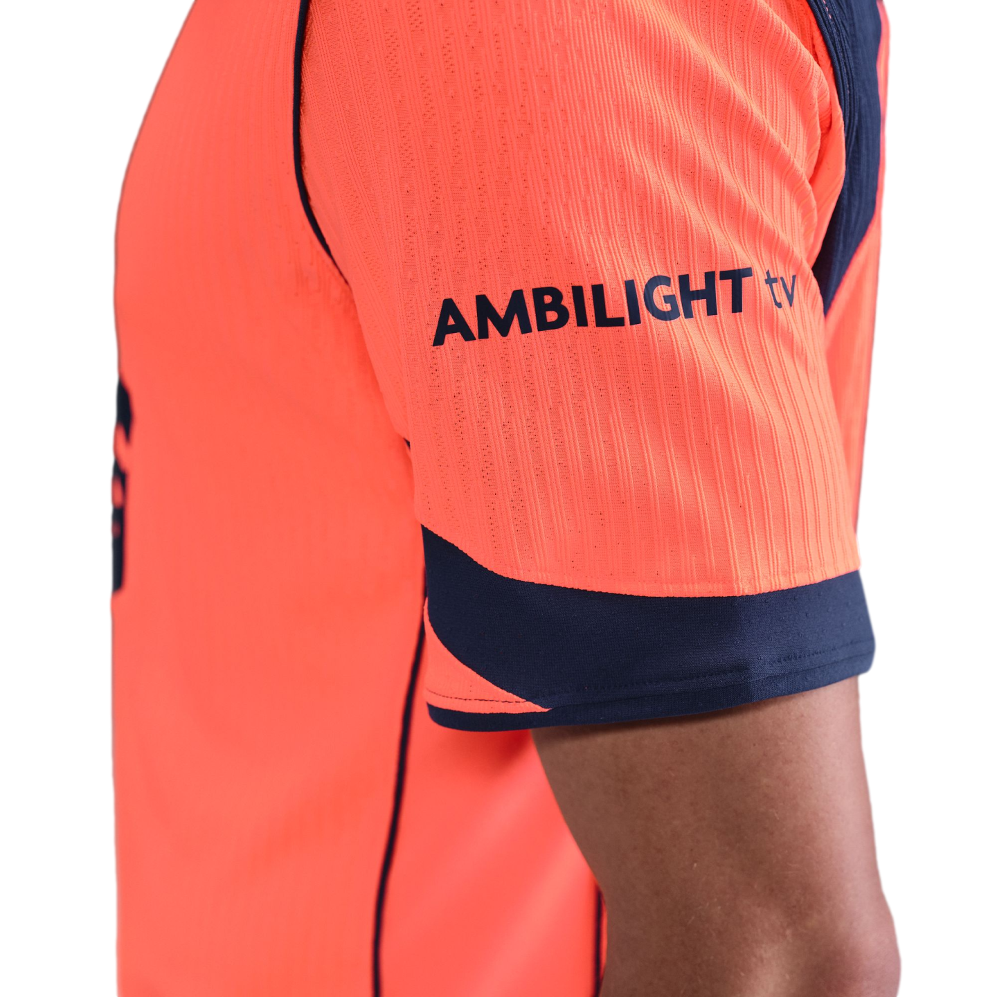 Close-up of the sleeve of an orange sports jersey featuring a navy blue "AMBILIGHT tv" logo.