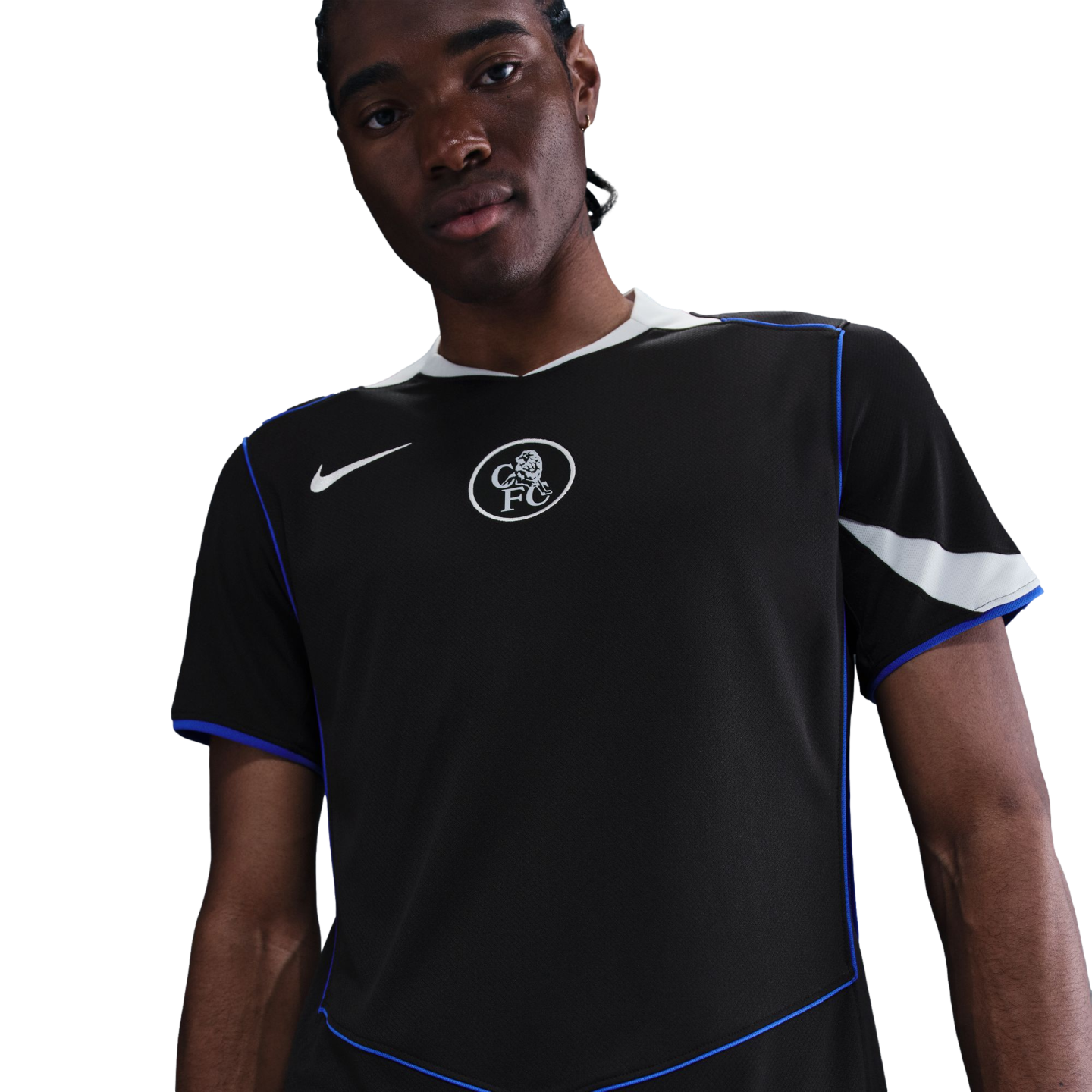 A man in a black Nike Chelsea FC jersey with blue piping and a white crest, against a solid black background.