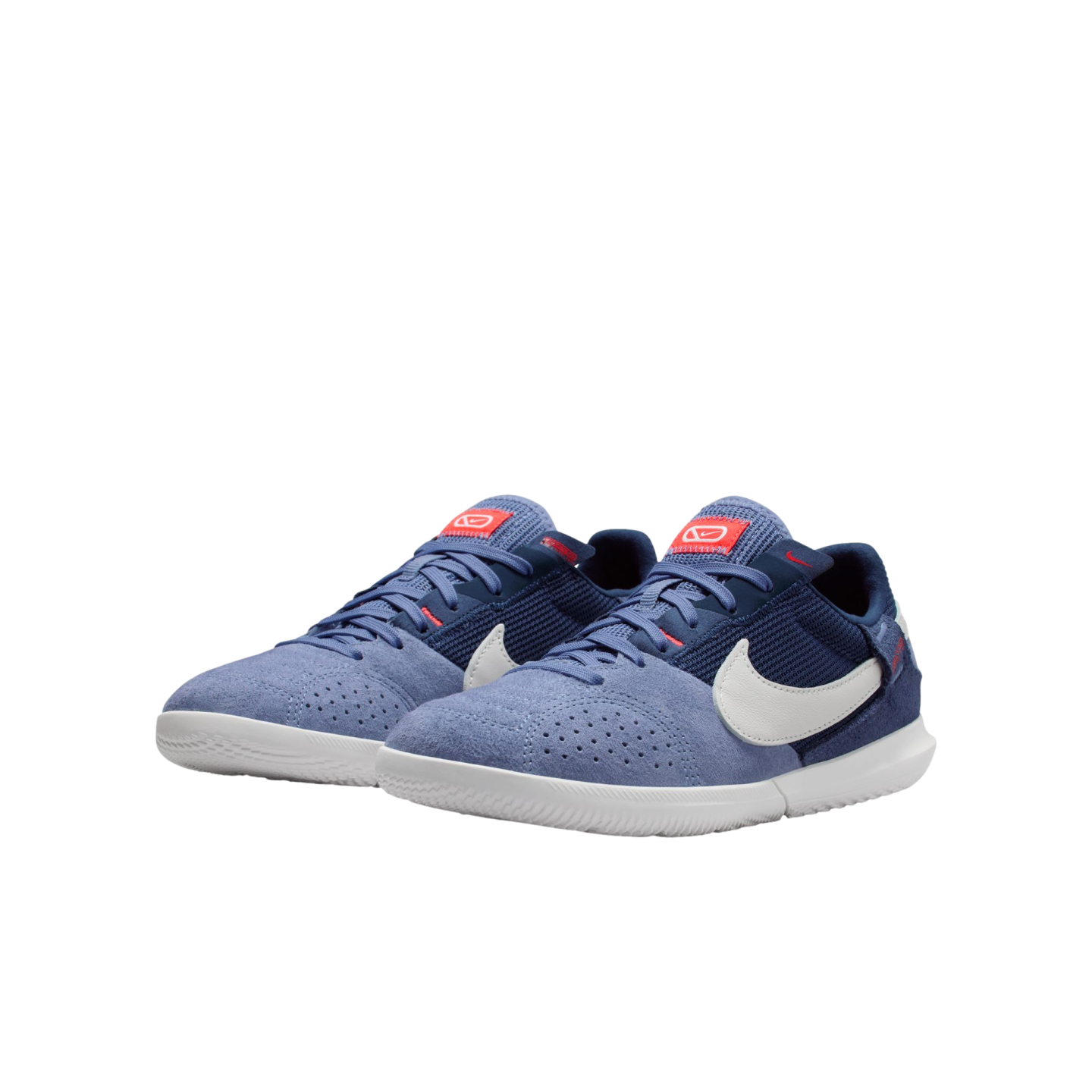 Pair of blue and white Nike indoor soccer shoes on a white background. Features include a light blue suede toe, navy mesh upper, white swoosh, and flat white rubber sole.