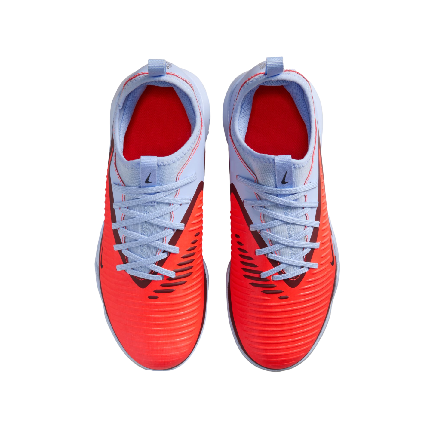 Top-down view of Nike soccer shoes with a textured bright red forefoot and light blue heel and laces, set against a black background.