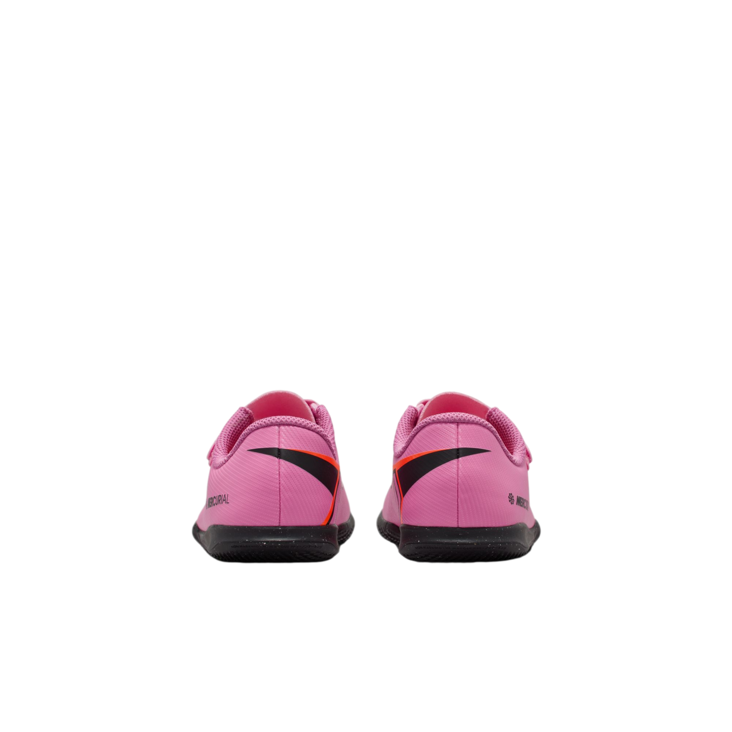 Rear view of a pair of pink Nike Mercurial soccer shoes with black and orange graphics, set against a solid black background.