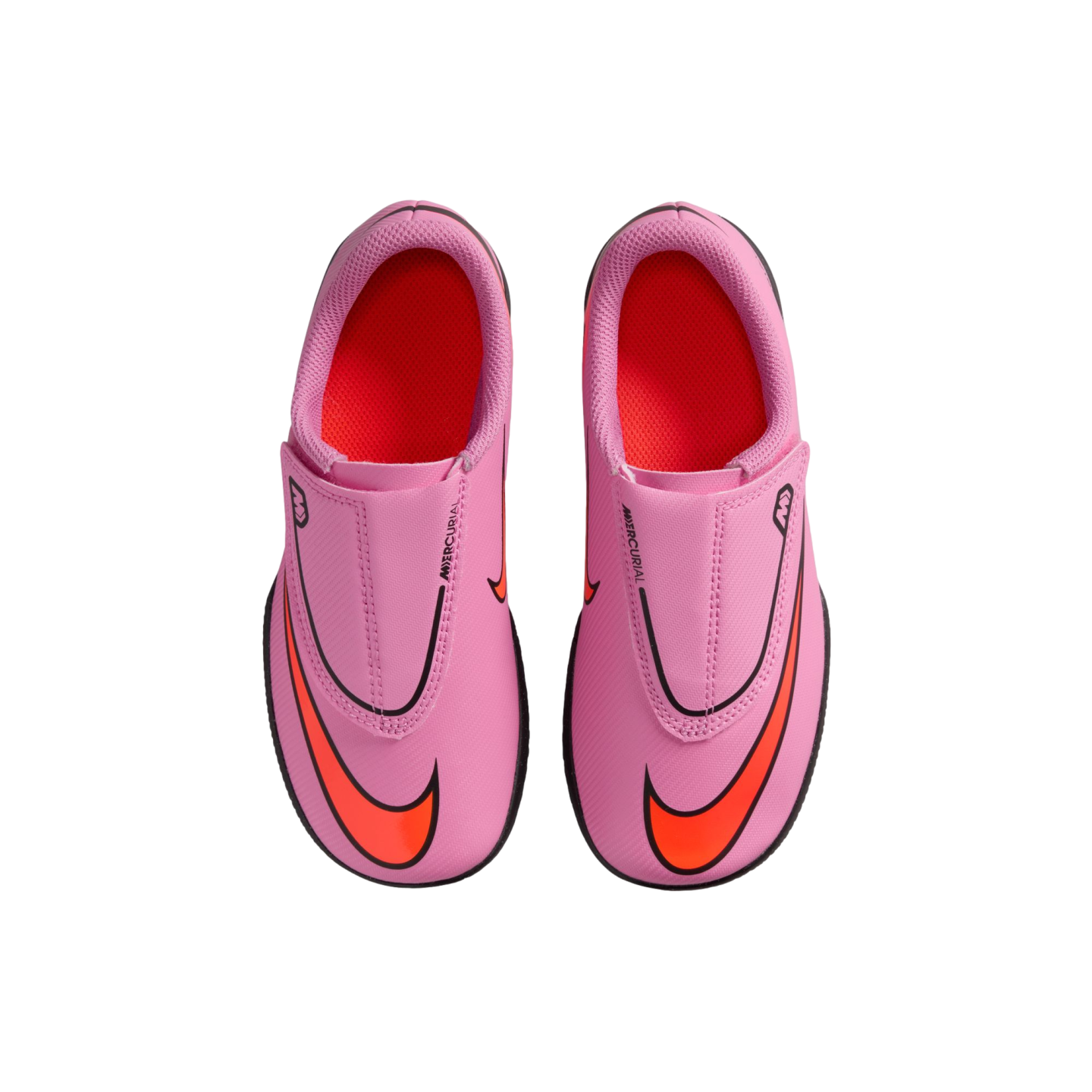 Top-down view of pink Nike Mercurial soccer cleats with bright orange swooshes and interiors, set against a solid black background.