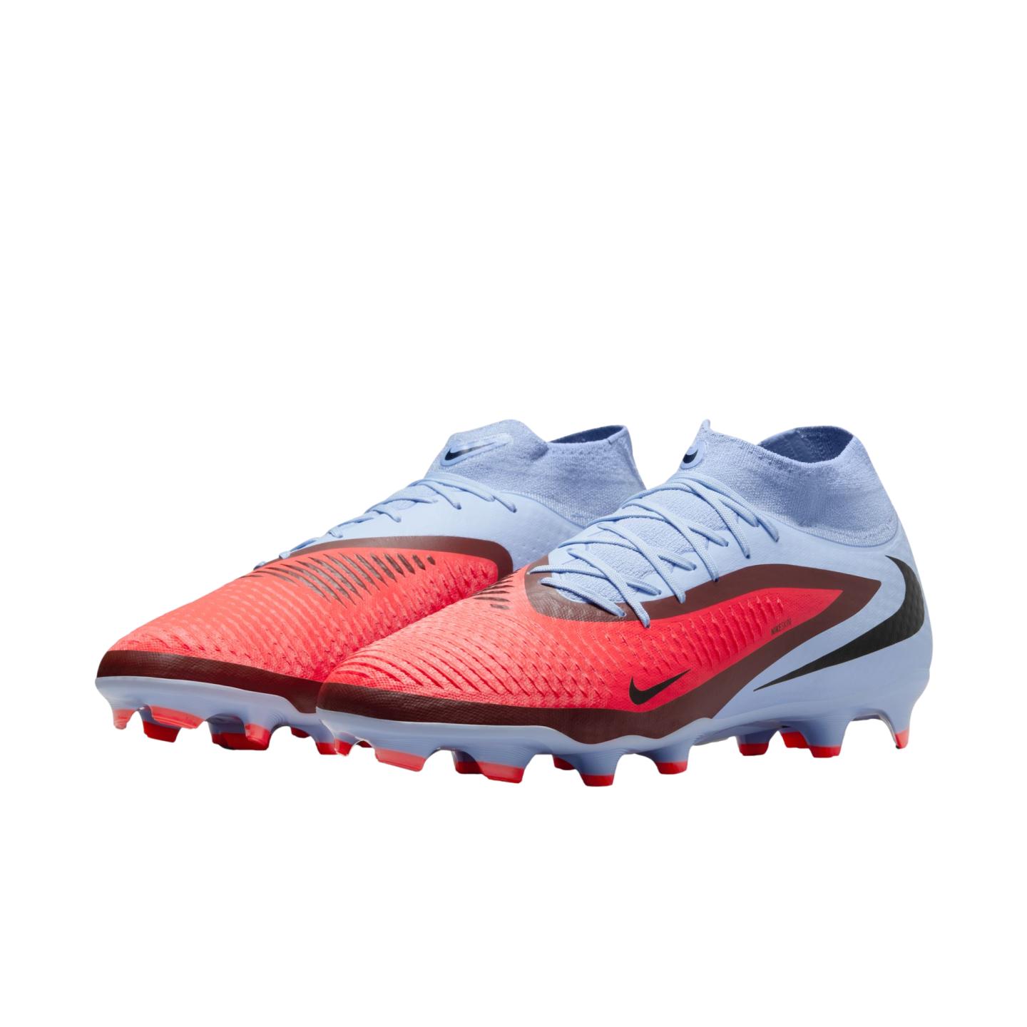 A pair of light blue and bright red Nike soccer cleats with high-top sock collars and textured uppers, set against a solid black background.