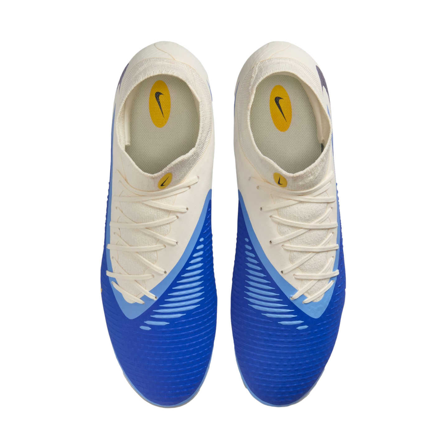 Top-down view of a pair of Nike soccer cleats featuring a two-tone blue and off-white design with matching laces, set against a solid black background.