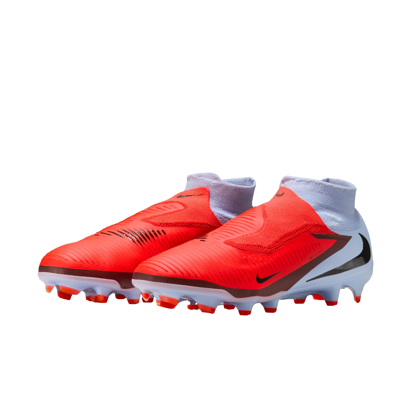 Nike soccer cleats with a bright orange forefoot, white heel, and integrated ankle sock. Features include black swooshes and firm-ground studs, shown against a black background.