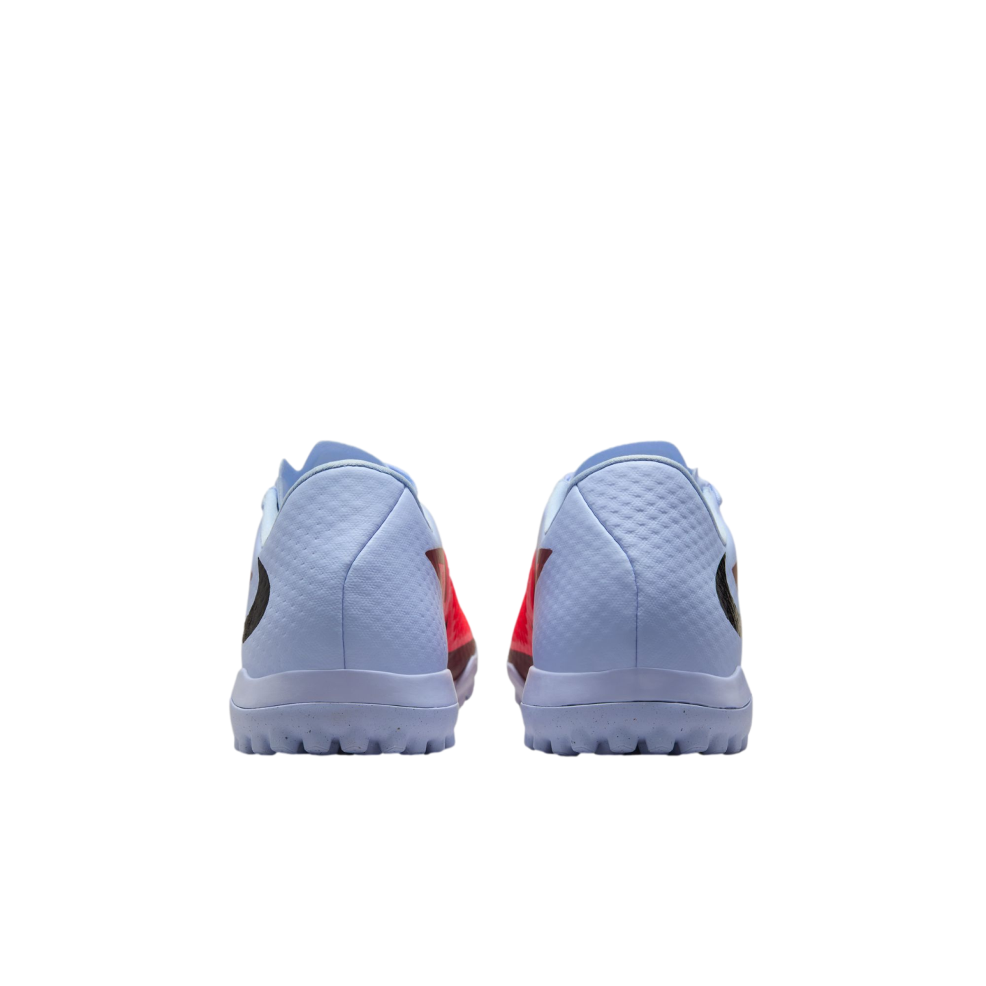 Rear view of light blue turf soccer shoes with orange accents and studded rubber soles on a black background.