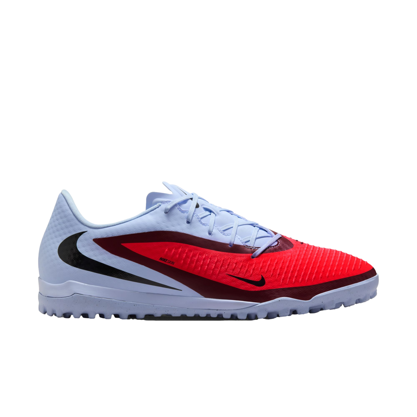 Light blue Nike turf soccer shoe featuring a bold red and maroon overlay, black swooshes, and a studded outsole, shown in profile.