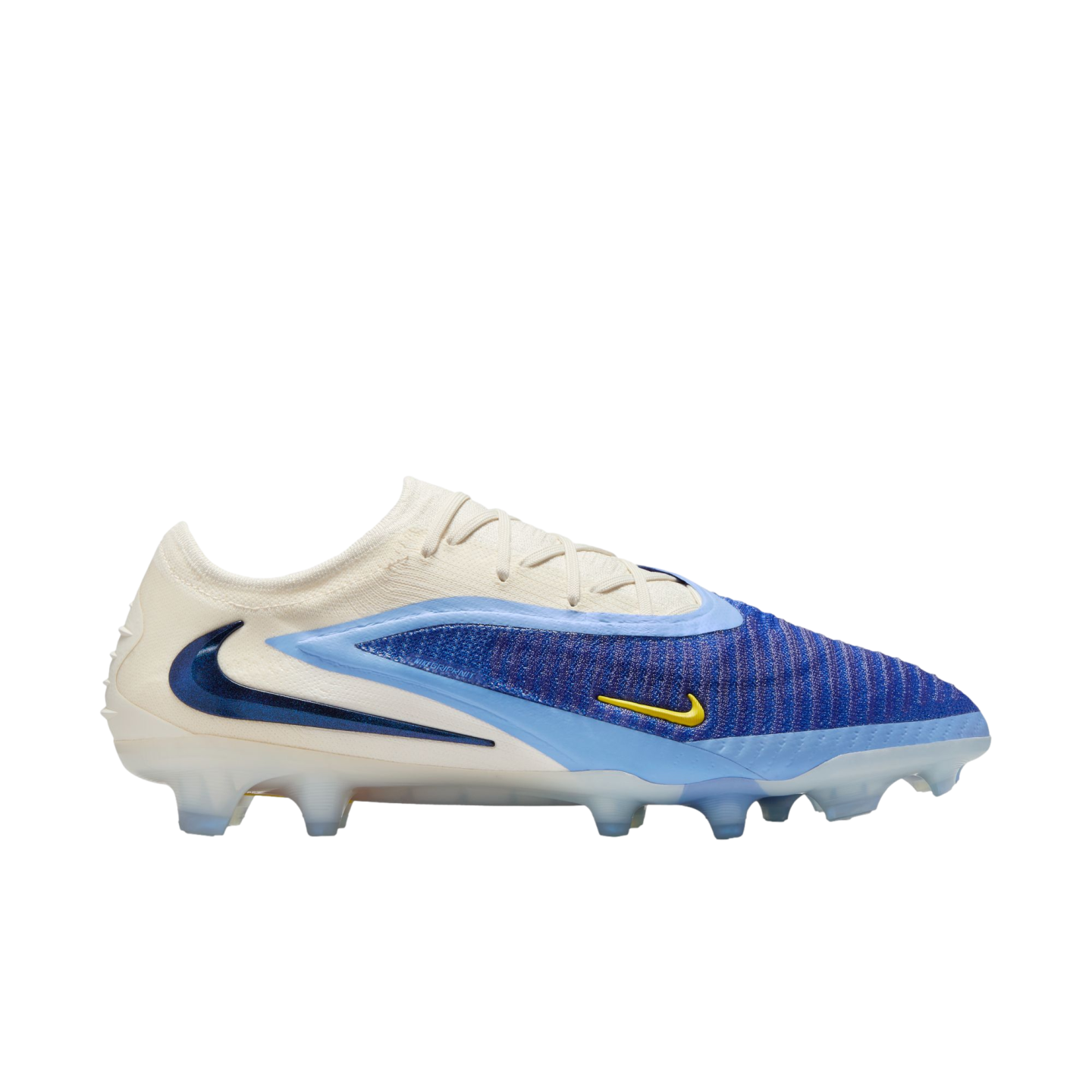 A side-view of a Nike Phantom GX soccer cleat featuring a cream, royal blue, and light blue design with a prominent dark blue swoosh on the heel and a small yellow swoosh.
