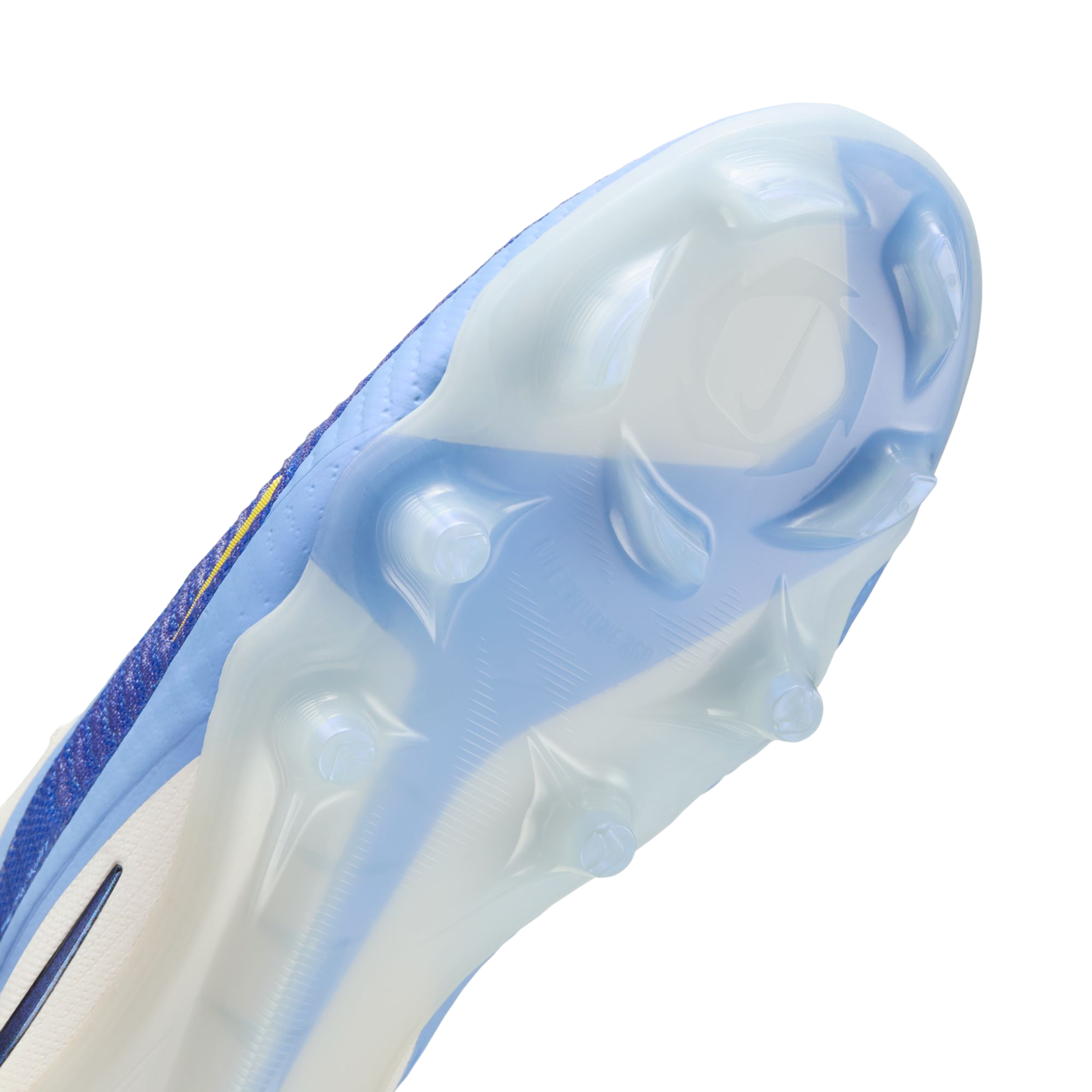 Close-up of the light blue and white soleplate of a Nike soccer cleat, showing translucent studs and a textured grip pattern.