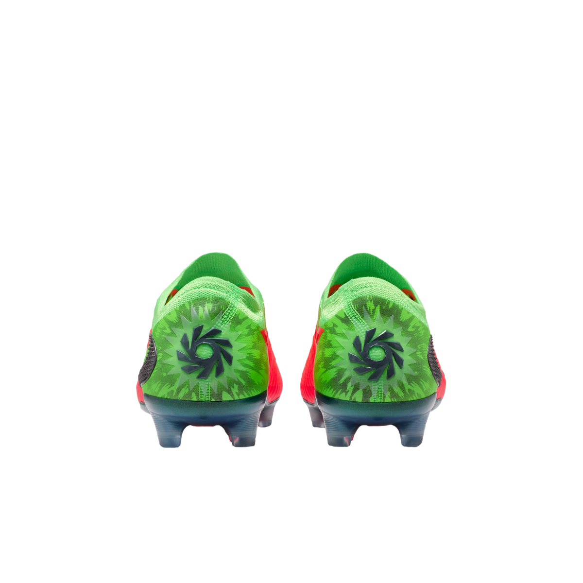 A rear view of a pair of bright green soccer cleats with a black circular logo centered on each heel, featuring a dark green starburst pattern against a solid black background.