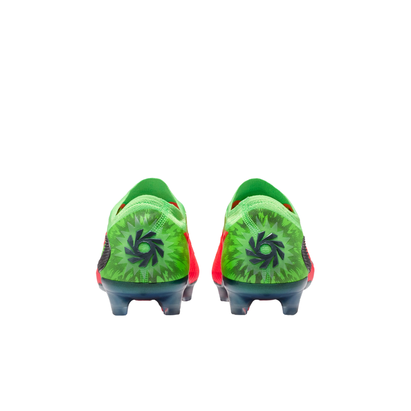 A rear view of a pair of bright green soccer cleats with a black circular logo centered on each heel, featuring a dark green starburst pattern against a solid black background.
