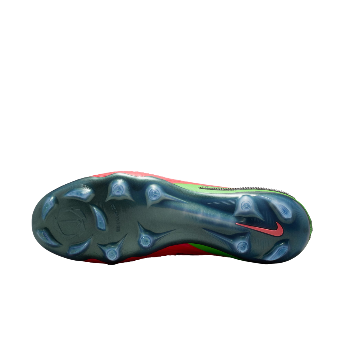 A bottom-up view of a Nike soccer cleat featuring an iridescent dark green soleplate with translucent studs. A small red Nike swoosh is visible near the heel, and the edges of the red and neon green upper are visible against a solid black background.