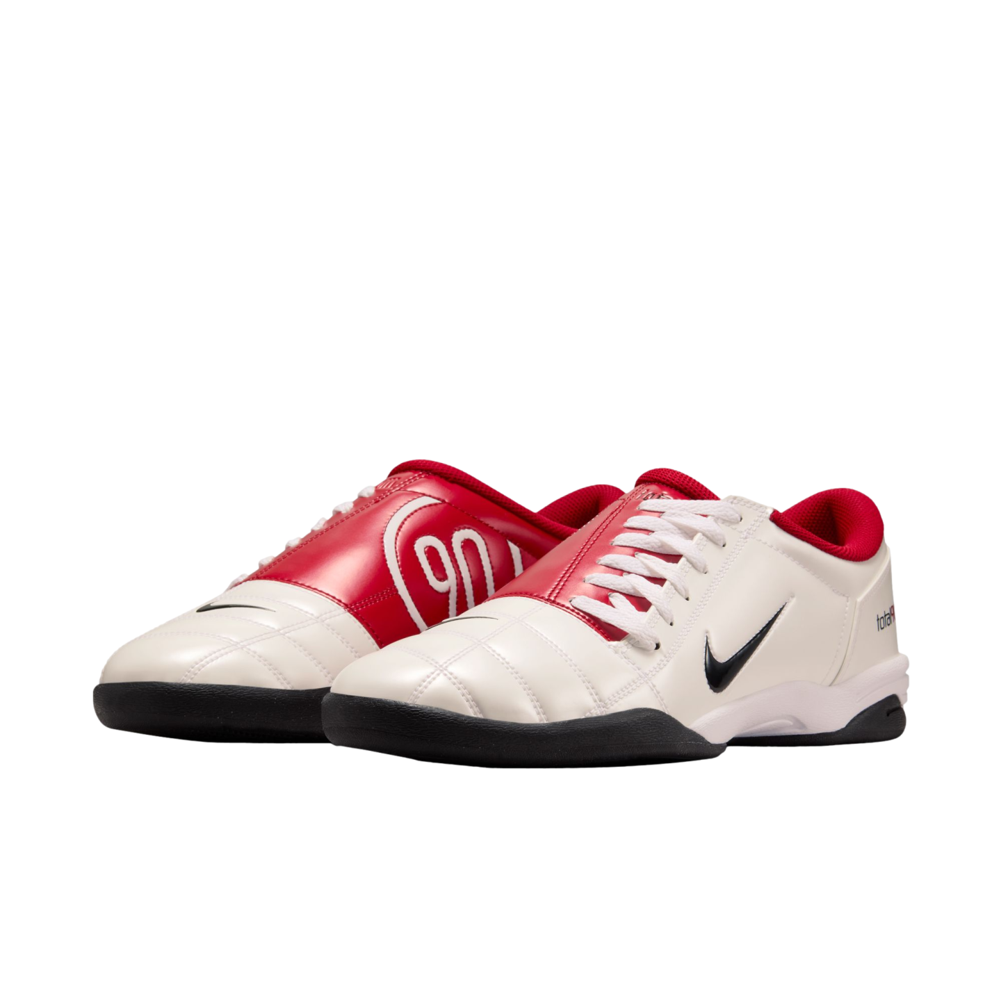 Pair of white and red Nike Total 90 indoor soccer shoes with black accents on a white background.