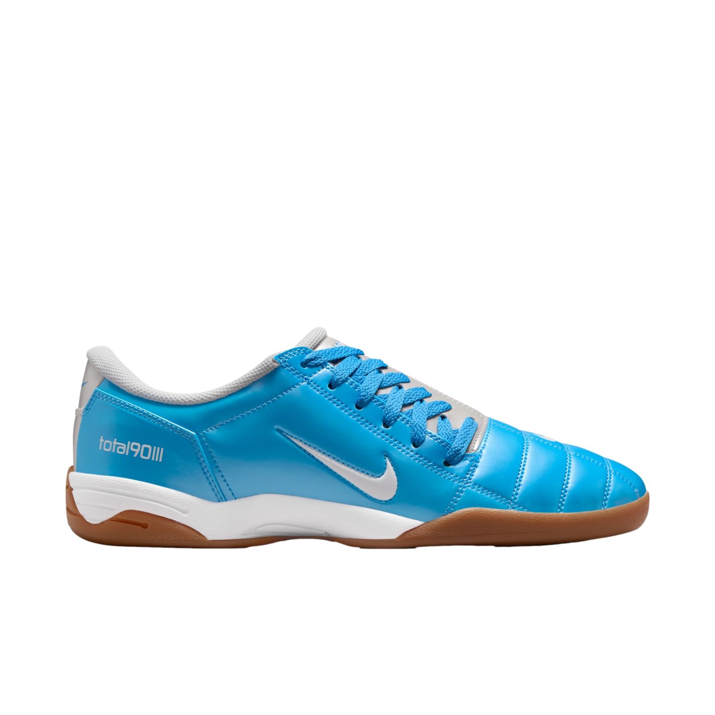 Side view of a bright blue Nike Total 90 III indoor soccer shoe with white accents and a gum rubber sole, set against a black background.