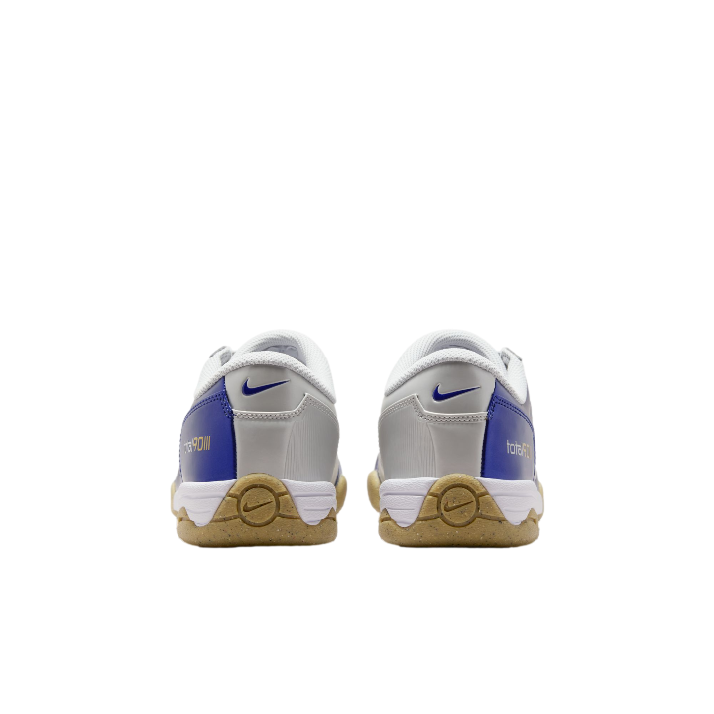 Rear view of white, blue, and silver Nike Total 90 III indoor soccer shoes on a black background.