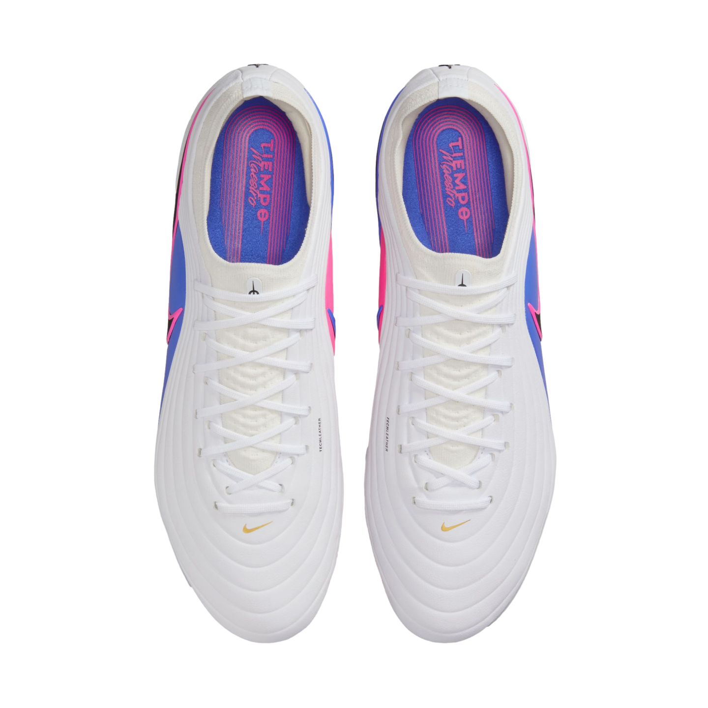 Top-down view of a pair of white soccer cleats with white laces and pink and blue accents. The colorful insoles feature "TIEMPO Maestro" text.