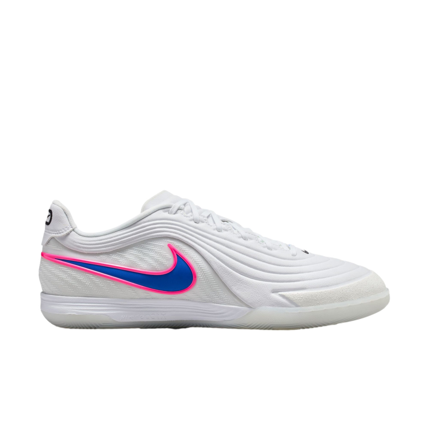 Profile view of a white Nike indoor soccer shoe featuring a blue Swoosh with a pink outline. It has a textured upper and a translucent outsole, shown against a solid black background.