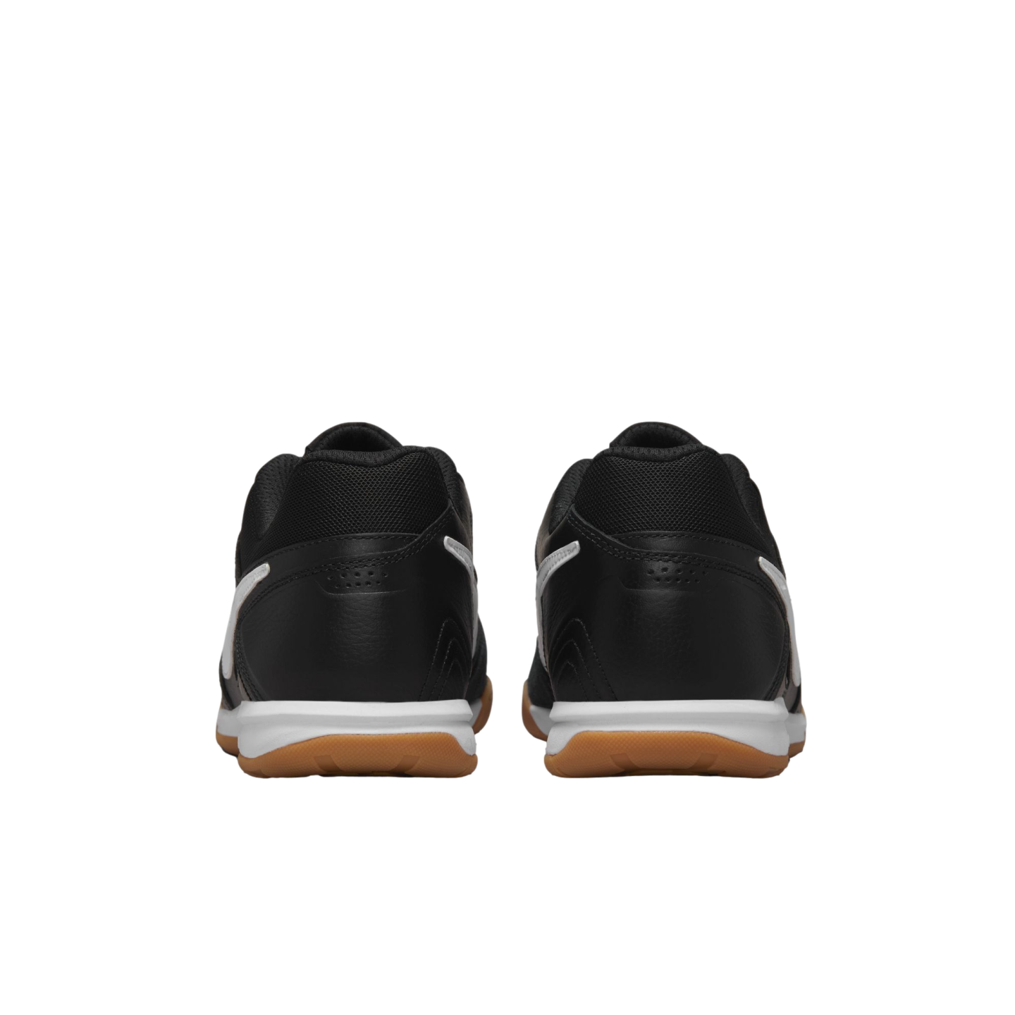 Rear view of a pair of black athletic shoes with white midsoles and gum outsoles against a black background.